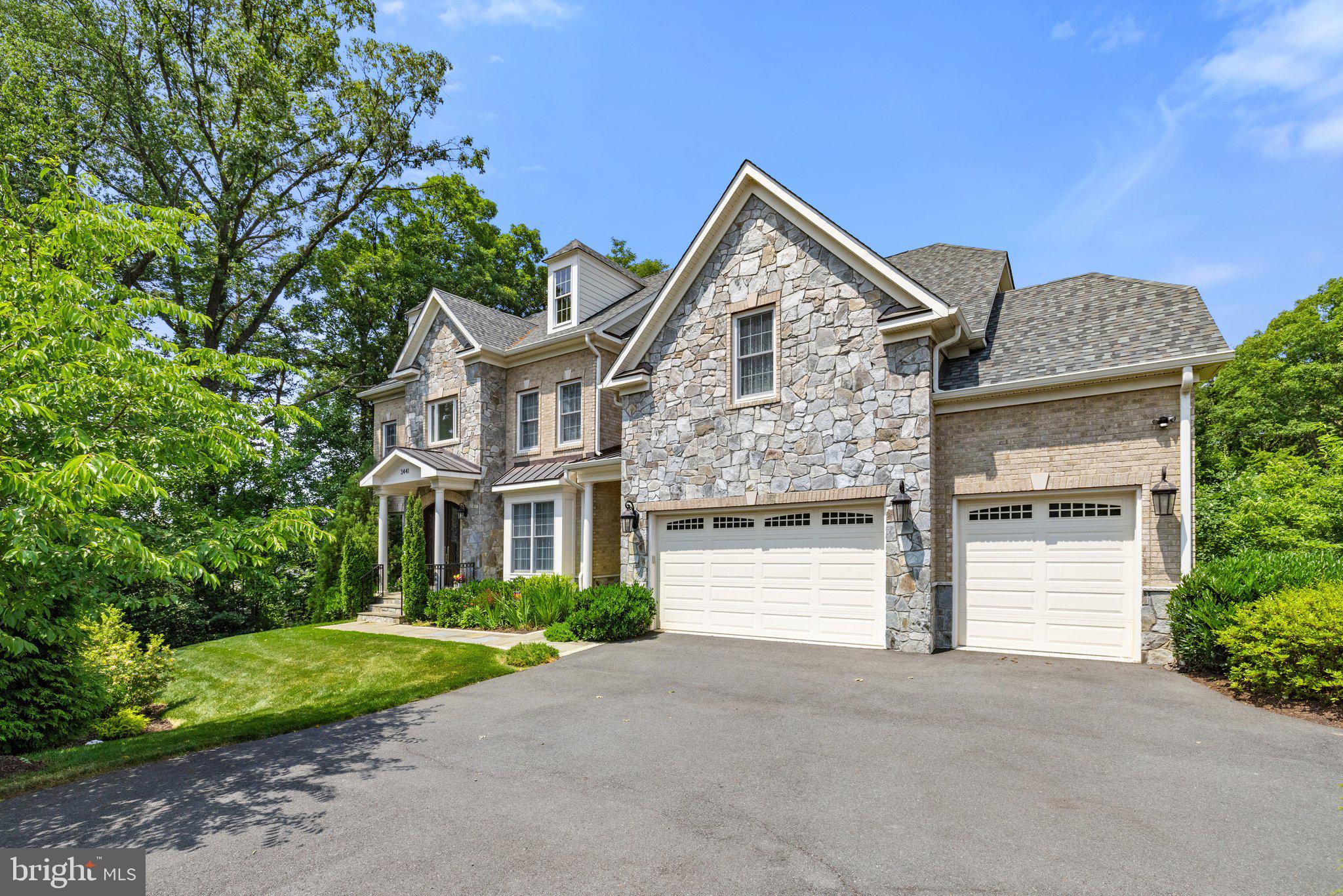 Luxurious custom home on a half-acre lot with approximately 7000 square feet of living space, seven bedrooms and six and a half baths, and elevator in desirable Woodburn Estates! No detail has been overlooked with stunning architectural features and a brick and stone facade.  10' ceilings on the main level, 2 story foyer with marble flooring and solid oak circular staircase. Gourmet eat-in kitchen with stainless steel appliances, granite countertops, custom cabinetry, and butlers pantry.  Main floor in-law suite with full bath and walk-in closet. Foyer and hall open to dining, living, and family rooms, and a separate office, perfect for virtual work.  The large deck can be accessed through three separate entrances on the main level, and staircase to tree-lined back yard and vast open space.  9' foot ceilings on lower and upper levels.  Extensive hardwood flooring.  Gas fireplaces in family room, primary bedroom, and recreation room.  2-piece crown molding in living room, dining room, and powder room. 3-piece crown molding in foyer and upper hall. Chair railing and shadow boxes in dining room.  High-end lighting fixtures throughout.  Primary suite includes spacious walk-in closets, Jacuzzi soaking tub, his and hers toilets, dual Moen shower heads, ceramic tile, and cultured marble sinks.  Four additional bedrooms upstairs with two additional full bathrooms and one Jack and Jill bathroom.  Upstairs laundry room with sink. Walk-out lower level with two separate entrances.  Seventh bedroom with full bath.  Recreation room featuring wet bar with granite countertops.  Theater room, large storage room, and additional flex room.  Elevator services all levels.  3 car garage.  Andersen Low E tilt-out windows, Peach tree 8-foot doubly entry doors, 2x6 construction, R-38 insulated ceilings.  Unbeatable location - minutes from INOVA Fairfax hospital, I-495, Route 50, Dunn Loring Metro, and Tysons Corner.