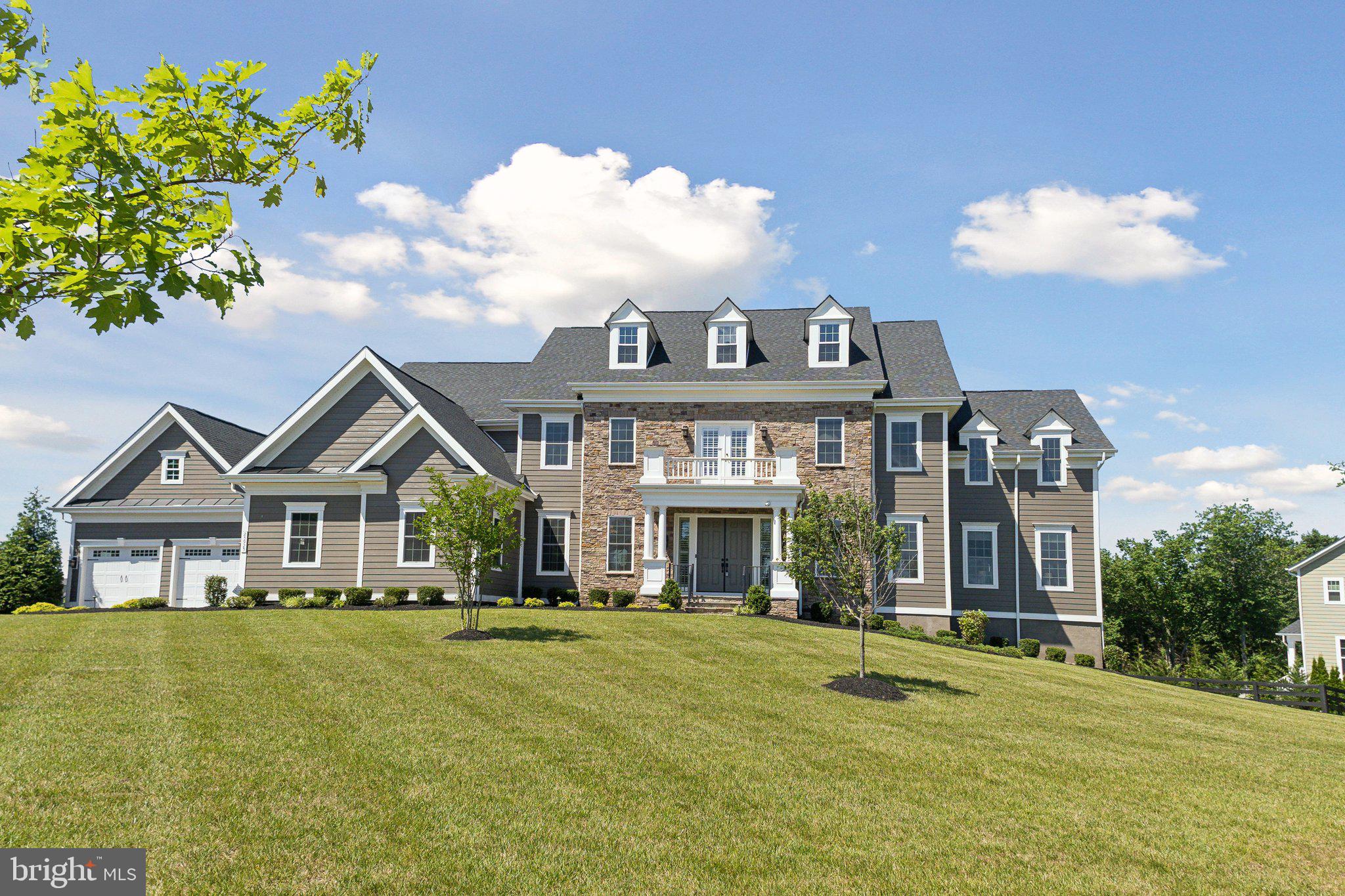 Welcome to your new home in the prestigious Greens South-Willowsford community. This magnificent Monticello II Model by NV Homes is situated on one of Willowsford's largest home sites, spanning over an acre and backing to serene woodlands, just moments away from The Greens Village amenities.


Boasting 9,224 square feet across three levels, this estate features seven bedrooms and seven and a half bathrooms and custom closets in EVERY closet. The main level impresses with a sophisticated curved staircase, high ceilings throughout, two home offices (one with built-in cabinetry), and a two-story family room with a coffered ceiling and gas fireplace, providing an ideal space for relaxation after a long day. The elegant kitchen is equipped with a large island, six-burner cooktop, double ovens, dual dishwashers, and a butler's pantry, seamlessly connecting to the morning room and dining rooms. Additional main level highlights include a large bedroom with an ensuite bath, a huge custom pantry and storage closet, a powder room, and a covered porch with inviting views of the surrounding landscape. An expanded mudroom with an informal front entrance and a four-car garage (outfitted with two 240 volt EV outlet chargers) provides added convenience and ample space for vehicles and storage.


Ascending to the upper level, discover the expansive owner's suite with a tray ceiling, a separate sitting area leading to a private balcony, and a designer master bath with dual vanities, a soaking tub, a luxurious walk-in shower for two, a water closet, and two huge walk-in closets customized by Closets by Design. You’ll also find four large additional bedrooms, each with en-suite baths and custom closets. A bonus living area provides extra space for relaxation or entertainment, and a large laundry room with a laundry sink and tons of cabinetry round out the upper floor.


The lower level includes a large recreation room with walkout access, a wet bar, a home theater with professional-grade equipment, a bedroom with a full bath, an exercise room, a large pantry with a refrigerator and three storage rooms.


Embrace the Willowsford lifestyle with two clubhouses, resort-style pools, splash parks, lush parks, gyms, a 7-acre lake with a boathouse, dog parks, maintained trails, sledding hills, campgrounds, and more. Join community events, cooking demonstrations, amphitheater concerts, and more. Willowsford, a 4,000-acre farm-to-table community with its 300-acre farm, garden, market, conservation areas, and miles of walking trails, is conveniently located less than 15 miles from Dulles International Airport and 35 miles from Washington, DC, and just minutes from top-rated schools, shopping, grocery, and dining.