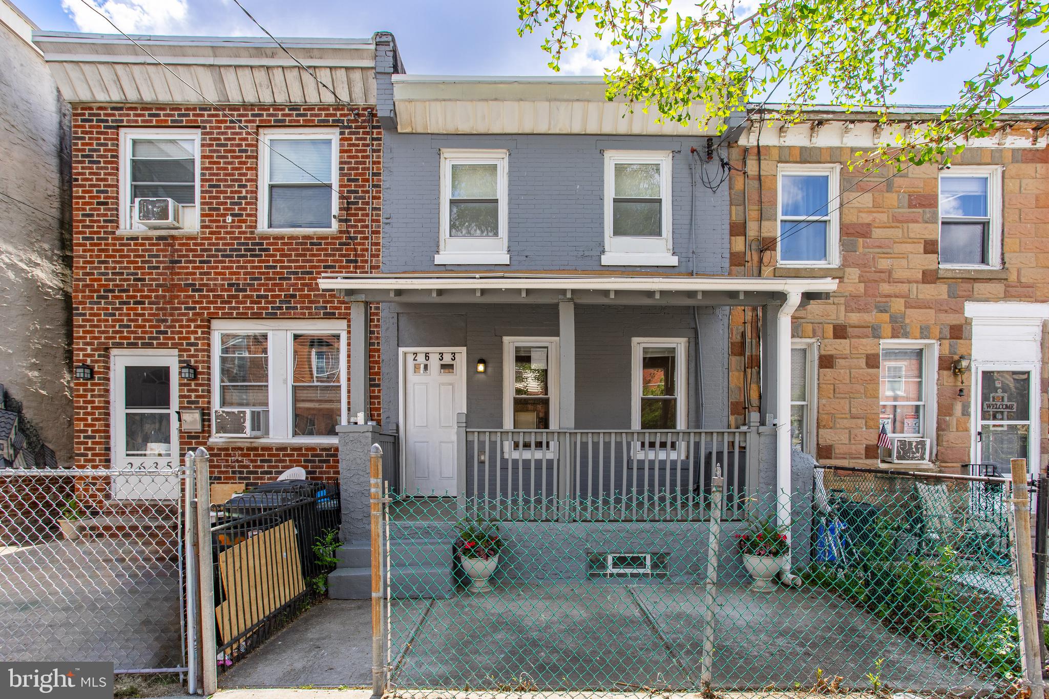 Welcome to the fantastic house on a recently very popular block of Braddock Street. This is a newly remodeled two-bedroom and two full-bathroom urban home in the heart of East Kensington. The first floor is designed as an open space uniting the dining and living areas and providing you with additional possibilities to arrange the space according to your needs and creativity. The wall structures enable you to place shelves and make it a convenient space for your books. The interior of the first floor is completed with a modern, contemporary kitchen equipped with quality Samsung appliances: a gas stove, a dishwasher, and a stainless steel refrigerator. The engineered wood floors' dark brown walnut hue provides a nice contrast to the white walls, and emphasises natural light entering through the front and back windows.
There is a nice-sized porch at the front and a beautiful backyard that you can use as a summer getaway, playground, or a gardening project; it is all up to you. The second floor starts with a master suite at the front with a standing shower and plenty of closet space. In addition, there is a full bathroom tastefully designed in white and off-white tiles. The second floor is concluded with a backroom with a closet space. The house has a full HVAC and an electric water heater. The basement is a full plan, with a lot of space for your extra needs; think of recreation, personal space, and storage. Please, book your showing.  All offers will be considered.