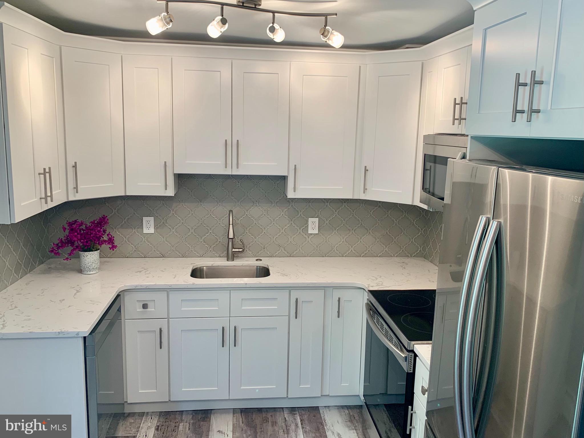 Beautifully renovated house with large park-- like setting rear yard is now ready for the new owner!   New flooring you will notice as you walk in to the large livingroom.  The dining area overlooks the large yard that backs up to the green belt.   Unbelievable kitchen with custom and designer backsplash, quartz counter top, stainless steel appliances along with a built in microwave hood to free up counter space.   On this main level are also two bedrooms and a gorgeous full bath.   With all this on the main level you also have a bonus room that is fully carpeted. The rear door leads to the oversized private back yard with a concrete patio, perfect to make a backyard oasis and outdoor living space.  You can add a pool, trampoline,  super size shed and still have plenty of yard space left.   The upper level has two bedrooms and another full bath that also has been renovated.  All of this plus brand new roof, newly painted inside and out!  Make your appointment this week!