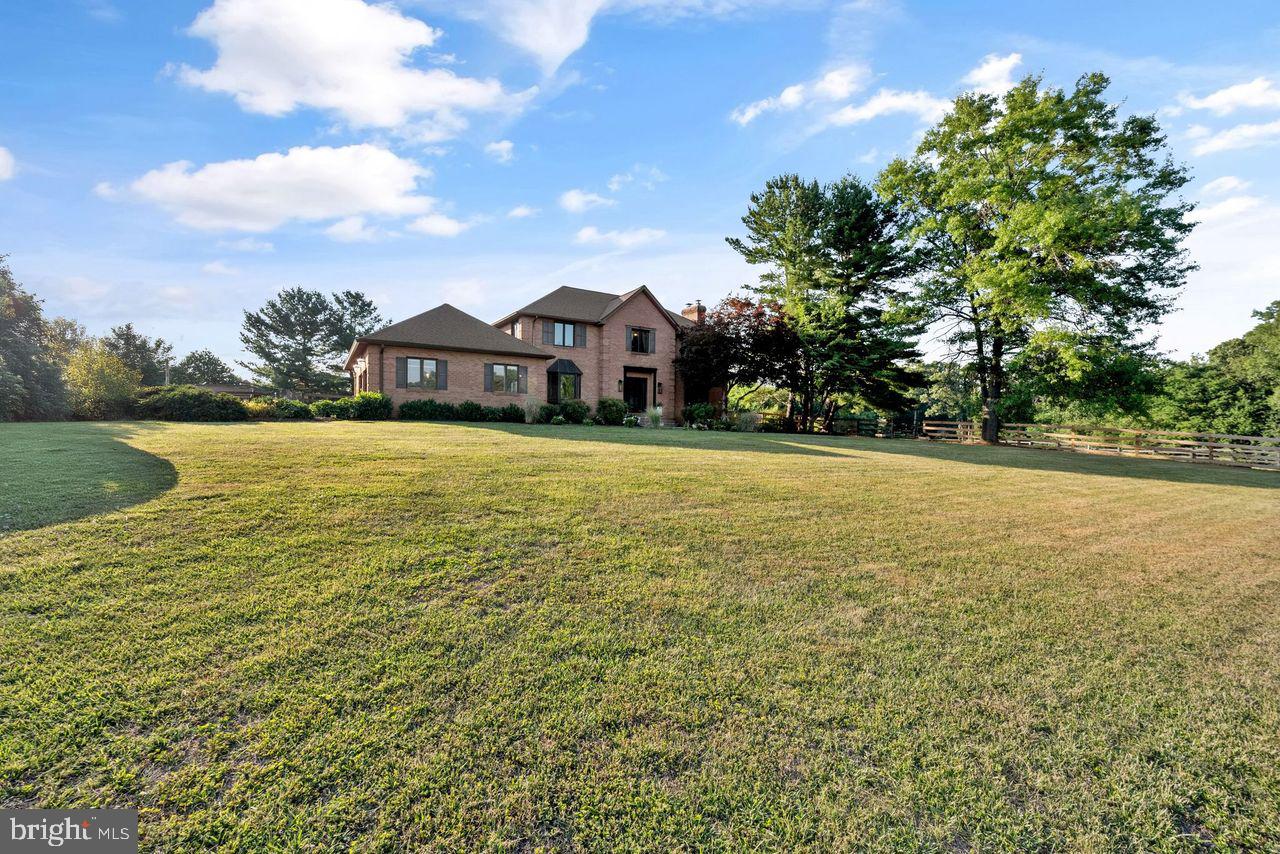 Welcome to your private sanctuary. Positioned on just under 7 rolling, fenced acres this commanding all-brick, 3-story stately home offers 5 bedrooms and 3.5 baths of meticulously renovated living space. Completely updated from top to bottom, this property represents a rare market opportunity where architectural beauty, high-end functionality, and a luxury recreational lifestyle converge.

Architectural Elegance & Curated Interiors

From the moment you step inside, the home’s thoughtful design and structural integrity are immediately apparent:

Grand First Impression: A dramatic foyer centers around a stunning, fluidly curved staircase, setting a tone of timeless elegance.

Light & Flow: Classic arched transitions guide you effortlessly between main-level rooms, while expansive custom windows flood the home with natural light and frame the landscape.

The Chef’s Kitchen: Engineered for premium functionality, the expansive kitchen features a custom quartz island, induction cooking, high-end stainless steel appliances, and a striking copper sink. Smart storage additions include an appliance garage alongside dedicated coffee and breakfast stations wrapped in full-height quartz backsplashes.

Premier Outdoor Amenities & Equestrian Infrastructure

Designed for the seamless transition between active recreation and quiet relaxation:

Resort-Style Living: An entertainer’s dream featuring an in-ground saltwater pool, a private tennis/pickleball court, a charming gazebo, and a mature, fruit producing orchard.


Turnkey Equestrian Facilities: A premier 4-stall barn equipped with a large tack room, dedicated water, and electricity—perfect for enthusiasts or hobby farmers.

Advanced Efficiency & Sustainability

Smart buyers will appreciate the significant capital investments made toward low-overhead, eco-friendly operations:

3 Year old Geothermal System: Top-of-the-line geothermal system provides unparalleled year-round climate control.

Enhanced Thermal Envelope: Recently upgraded, blown-in insulation maximizes energy retention and ensures exceptionally low utility costs for an estate of this scale.

Unparalleled Panoramas

True luxury is defined by your surroundings. Positioned perfectly to capture the landscape, this estate offers breathtaking, unobstructed views from every single angle. Experience the tranquility of spectacular sunrises to start your morning and watch the day fade away with striking sunset vistas.


The Bottom Line: A rare, asset-rich find that perfectly balances sophisticated updates with sustainable, self-contained acreage living. Open House this Friday, July 17th  5:30-7:30 pm! Come and enjoy this beautiful home.