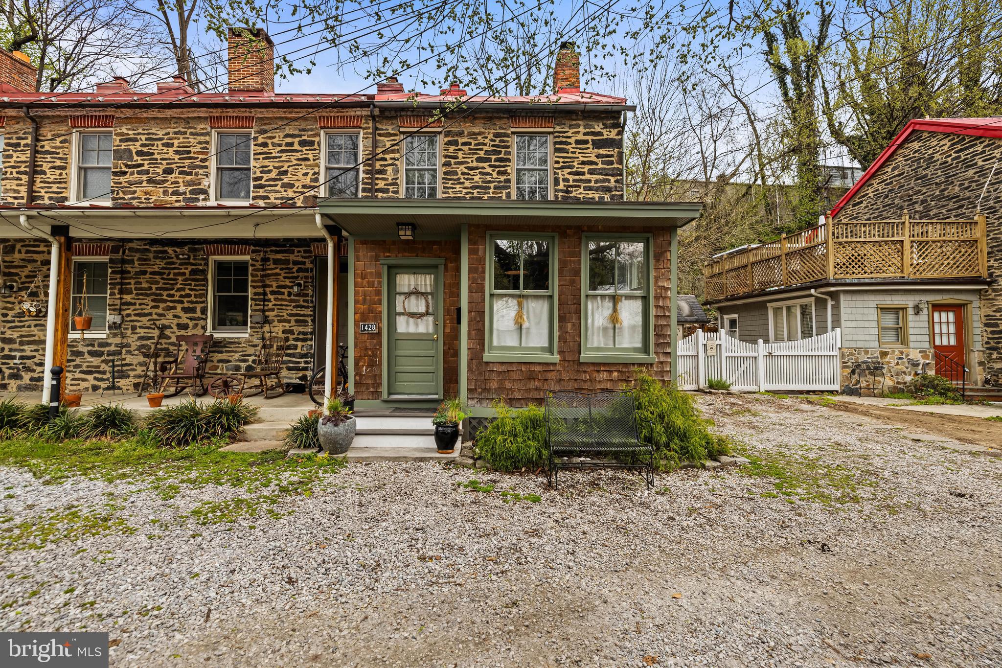 Welcome to a thoughtfully reimagined piece of Baltimore History in the heart of Historic Hampden. Originally constructed in the 1840s as worker housing for the Whitehall Cotton Duck Mill, this timeless property seamlessly blends historic charm with modern comfort. Original hardwood floors and authentic stonework are a testament to the care and craftsmanship that define this home. A complete gut renovation in 2021 brought this historic gem into the present day, including a mudroom addition that could instead be used as a home office or creative studio. In the rear, a kitchen addition features soaring ceilings and is bathed in natural light from multiple skylights. The kitchen is a showstopper, sun-drenched and spacious, with an oversized pantry offering custom shelving and abundant storage space. Step into the inviting living room where exposed timber beams and a striking stone fireplace create a warm and rustic atmosphere. The adjacent dining area offers ample space to host gatherings and showcases another fireplace  that has been enhanced with a modern woodstove. On the first upper level, you'll find two well-appointed bedrooms and a full bath. Bedroom Two includes a charming homework or reading nook, offering serene views from the second story to the first. The second upper level features a large private bedroom with an ensuite bath including a tub and ample closet storage. Outside, enjoy a peaceful and beautifully landscaped backyard, ideal for morning coffee or evening relaxation. A one-car parking pad adds convenience. A handcrafted wood storage structure, crafted by the same artisan responsible for the stunning sliding barn door in Bedroom Two, is located on the side of the home. Situated just moments from local Hampden favorites, including the iconic "Avenue," the Clipper Mill Bike Path, and the scenic Jones Falls Trails, you’ll enjoy the perfect blend of urban lifestyle and outdoor adventure. Recent updates include: New kitchen appliances (2021), New washer, dryer, and water heater (2021), New 5-unit split HVAC system (2021), Custom pantry shelving by Ed Baldwin (2021), New stainless steel chimney lining system, top plate, rebuilt and regraded crown, exterior flashing, and woodstove (2022) and so much more! Don’t miss your opportunity to own this one-of-a-kind, meticulously restored piece of Baltimore history. Schedule your private tour today!