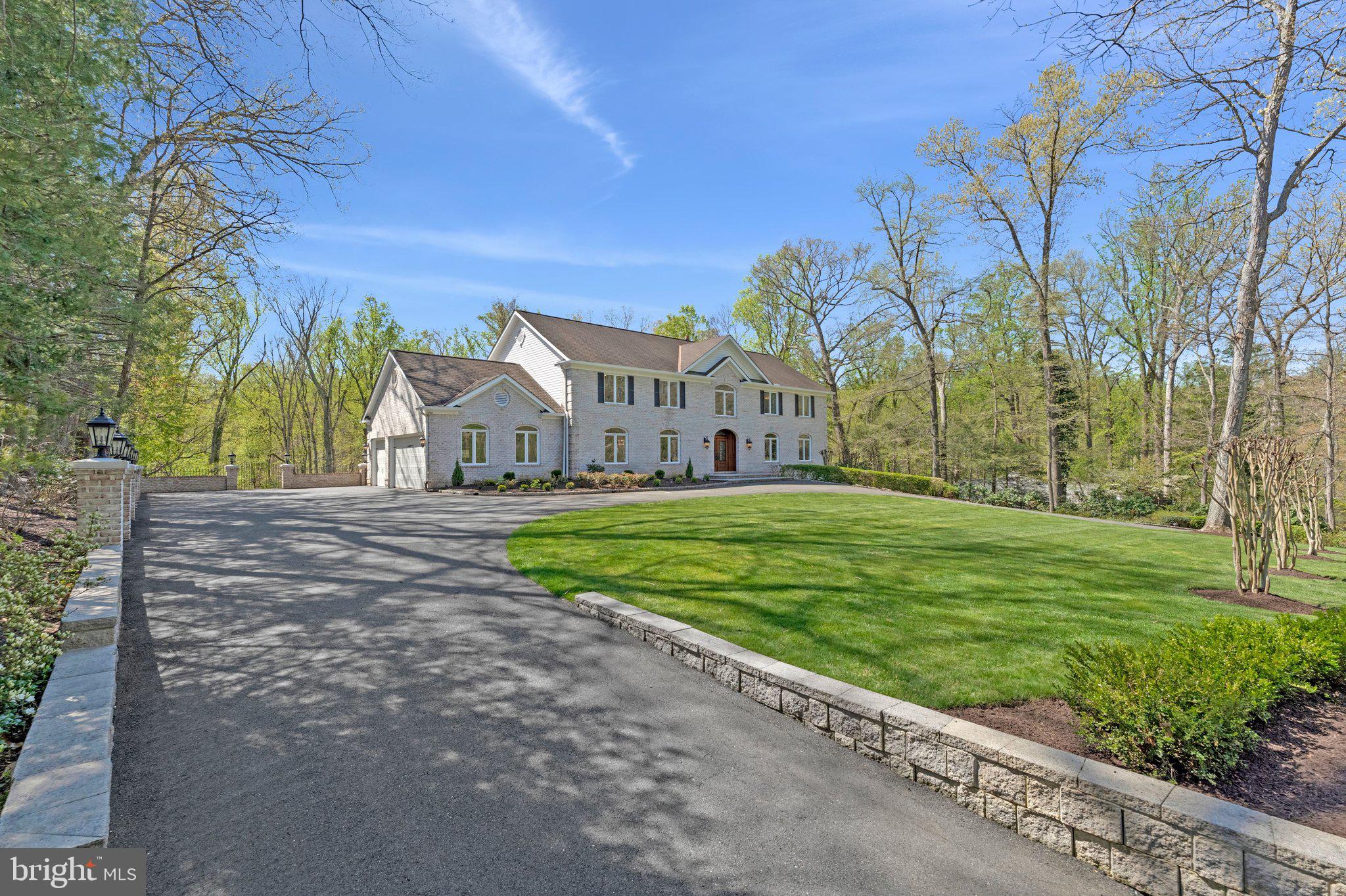 OFFER DEADLINE WEDNESDAY��APRIL 15, 2026, 12PM. 

Perched on a picturesque 1.9-acre lot in the sought-after community of Woodside Estates in McLean, this elegant and meticulously maintained 6,000+ square foot colonial offers 5 bedrooms and 5.5 bathrooms across three finished levels. Surrounded by mature trees and natural beauty, the home combines a sense of privacy and tranquility with exceptional convenience.

Throughout the residence, hardwood floors and recessed lighting span all levels, complementing the home’s timeless architecture and thoughtful design. Ideally positioned on the border of McLean and Great Falls, the property is just minutes from downtown McLean, Great Falls Village, Tysons Corner, and Reston, offering easy access to world-class shopping, dining, and major commuter routes.

The stately front entrance opens to a grand foyer with a graceful circular staircase and wrought iron banister, creating an immediate sense of elegance. The main level has been thoughtfully remodeled to include a separate formal living room and a spacious home office or library lined with built-in bookcases, ideal for both entertaining and working from home.

At the heart of the home lies the gourmet kitchen, beautifully appointed with a large center island, quartz countertops and backsplash, custom 42-inch white cabinetry, and top-of-the-line JennAir stainless steel appliances. Just beyond, the expansive family room serves as a warm gathering space, highlighted by a linear gas fireplace with stone surround, recessed television niche, and custom built-ins. French doors open to a generous covered deck overlooking the terraced backyard and the peaceful setting of Rocky Run Creek, creating a seamless transition between indoor and outdoor living. An elegant powder room completes the main level.

Upstairs, the welcoming primary suite offers a private retreat with a cozy gas fireplace, an elegant spa-like bath, and custom-designed walk-in closets providing exceptional storage and organization. Across the hallway are three generously sized bedrooms, each with updated en-suite full baths. A large upper-level laundry room with a view, offers ceramic tile flooring, cabinetry, and folding table adds everyday convenience.

The walk-out lower level is designed for both relaxation and entertaining, featuring a spacious recreation room with custom bar and gas fireplace. Sliding glass doors lead to an expansive flagstone patio and lawn, providing beautiful outdoor living space overlooking the wooded grounds. This level also includes an additional bedroom with en-suite full bath, perfect for guests or extended family. The level grassy area offers ample space for outdoor recreation and is ideal for the addition of a future pool.

With its classic open floor plan, elegant architectural details, spectacular natural surroundings, and exceptional location, this remarkable property offers the perfect balance of luxury, comfort, and everyday livability.

Video of property available online.