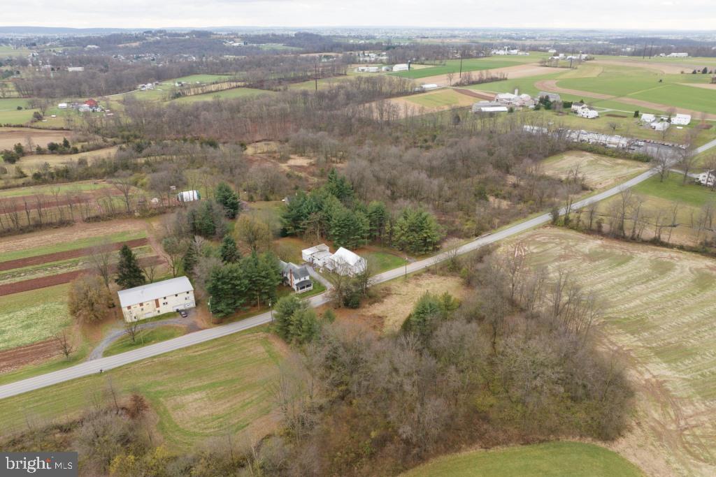 AUCTION DATE - THURSDAY, APRIL 2, 2026 AT 1PM. LISTED PRICE IS AN OPENING BID ONLY AND IS NOT INDICATIVE OF THE FINAL SALE PRICE. REAL ESTATE: 13.2 ACRES partially wooded w/2 houses. Main House: 2 sty. custom built dwl. w/1,656 SF finished area w/eat-in kitchen w/raised panel cabinets & appliances, dining rm. w/sliding patio door to rear deck 12x15, living/family rm. w/cathedral ceiling, office/loft area, 1st floor laundry, 2 bdrms., 2½ baths, full daylight bsmt., attic, propane forced air heat, central AC, attached 2 car garage & detached shop 20x18 w/overhead door & bsmt. w/elec. House well maintained, move in condition. 2nd House: 2½ sty. farmhouse w/2,320 SF finished area w/eat-in kitchen w/oak raised panel cabinets & appliances, dining area, living & family rms., great rm. w/stone hearth w/propane stove insert, 4 bdrms., 2 full baths, attic, bsmt. & covered porches. House in need of TLC. Outbldgs: 2 sty. frame shop w/attached 2 car gar., 2 sty. frame/stone bank barn 30x30 w/stable, shop area & 2nd floor hay storage & stone springhouse all on 13.2 ACRES partially wooded w/on-site well & septic. Zoned Ag. NOTE: Owners relocated to retirement quarters & motivated to sell! Ideally located country property w/2 dwls. on same deed. Minutes to Red Run, Fivepointville & Bowmansville w/easy access to Rts. 272, 897, 222 Bypass & Turnpike. Terms 10% down, balance 60 days or before. Personal inspection by appointment or open house Sat., March 14, 21 & 28 from 1 to 4 PM.