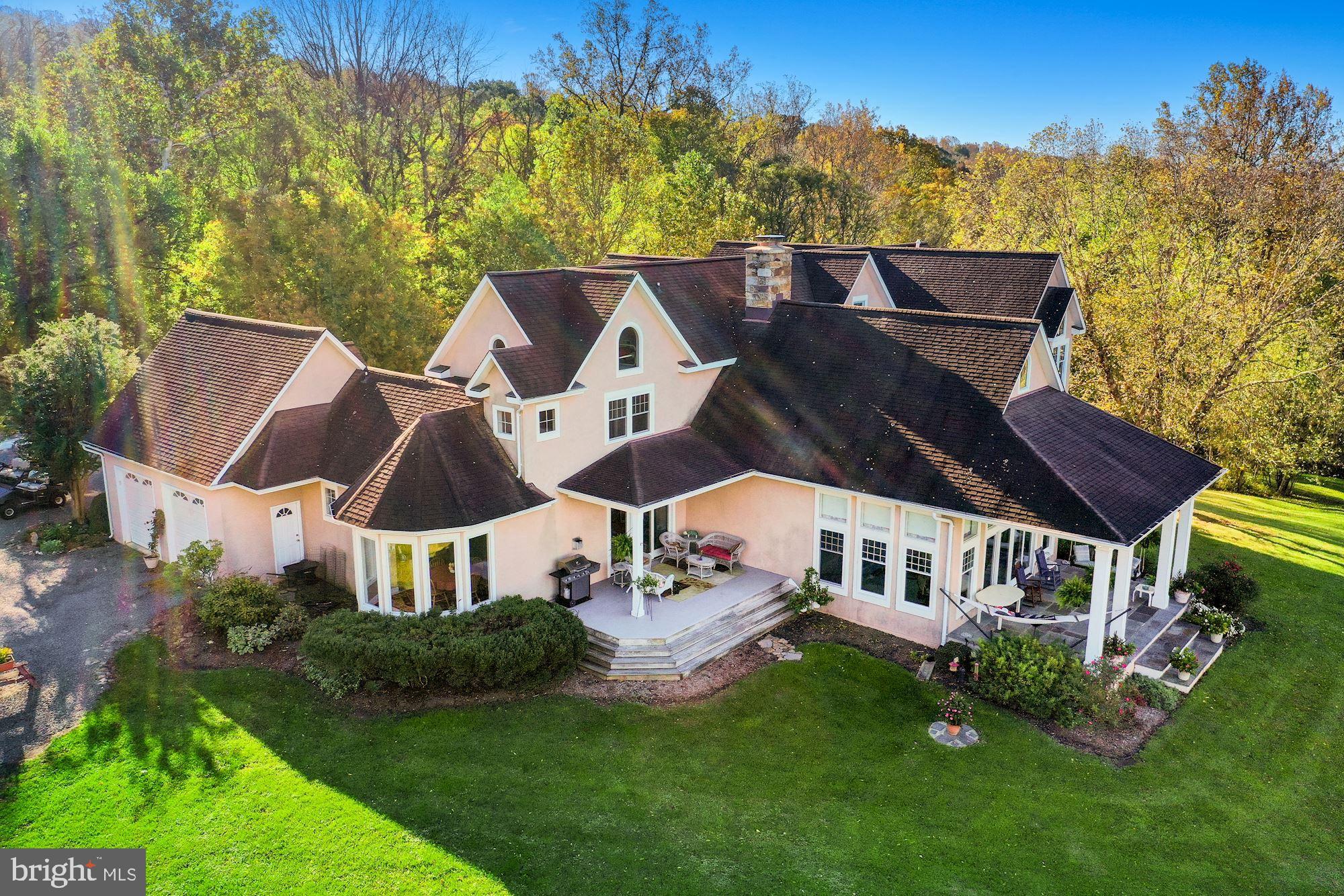Kingsley Lake and 62 Acres of paradise! 6531 SF Finished Space! Please see attached DRONE TOUR. 
A property so unique that it takes your breath away. A location so private that the only sound you hear is a Bluebird singing. Thirty-seven miles to the Washington Monument, 12 minutes to downtown Leesburg, 26 minutes to Dulles Airport, and 1,000 light-years from reality! 
This custom architecturally designed home sits on a private 62-acre wildlife preserve that boasts a semi-private 40-acre lake for family fishing, boating, and swimming. Nestled along the beautiful Catoctin Ridge and integrated with the remote Village of Mount Gilead, the parcel is incorporated as part of the original 774-acre tract which consisted of the 18th century historic Loudoun County landmark known as the Shelburne Glebe.  
This property and the contiguous landowners are protected under the guidance of the Virginia Department of Historic Resources, Loudoun County Goose Creek Historic District,  and the National Register of Historic Places, each of which contributes to the covenants and easements that serve to uniquely protect the environment from encroachment and further subdivision. 
With the land equally divided between forest and meadows, the natural beauty will seem to whisk you away to another place and time. You will enjoy the various hiking and equestrian trails as you experience connection with the variety of wildlife that surrounds you. You will immerse yourself in the incredible views of the western Loudoun Valley and the Blue Ridge mountains, experience a wondrously wide and spacious sky, and surrender to a sense of privacy that is truly profound.
As for the home itself, you will likely be thrilled to learn that you have high-speed Verizon FiOS internet connectivity. Plus, the home is custom built to last hundreds of years with a natural, original stucco and stone exterior, interior beams, lots of oak, a 36’ tall stone fireplace, and plenty of interior storage. 
A very special place where you can really get away without being far away. Truly magnificent!