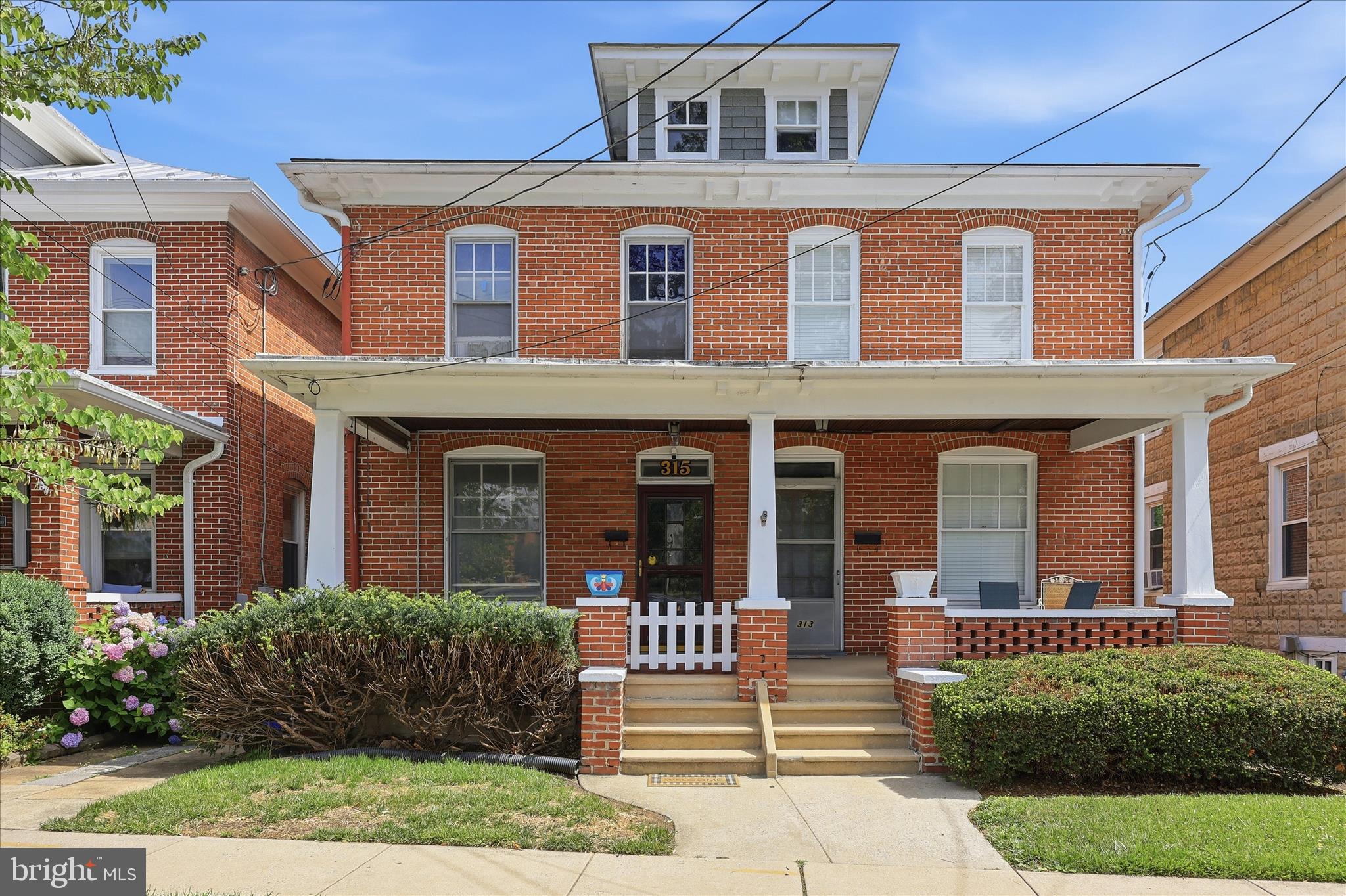 Charming 1920 townhouse ideally located just blocks from Market Street, Baker Park, Frederick Health Hospital, and major commuter routes. Rich in character, this 3-bedroom home features original hardwood floors, original wood doors, trim, and banister, blending historic charm with thoughtful updates.

The second floor includes an expanded full bath with an oversized tiled shower and exposed brick accent wall, plus a flexible third bedroom currently configured as a convenient laundry and dressing room. A newly added half bath provides additional functionality rarely found in similar homes.

The spacious, sunlit kitchen offers original character and ample room for future customization, providing an exceptional opportunity for renovation and personalization to suit your own style and needs.

The true highlight of the property is the private backyard retreat. Redesigned with extensive hardscaping, a built-in gazebo, mature shade trees, privacy fencing, and multiple entertaining areas, the outdoor space comfortably accommodates large gatherings while maintaining a peaceful, garden-like atmosphere. A detached garage/workshop offers exceptional storage and flexibility.

Located outside Frederick's Historic District, this home provides the freedom to enjoy historic character without historic district restrictions, all within walking distance of downtown Frederick's restaurants, shops, parks, and entertainment.
