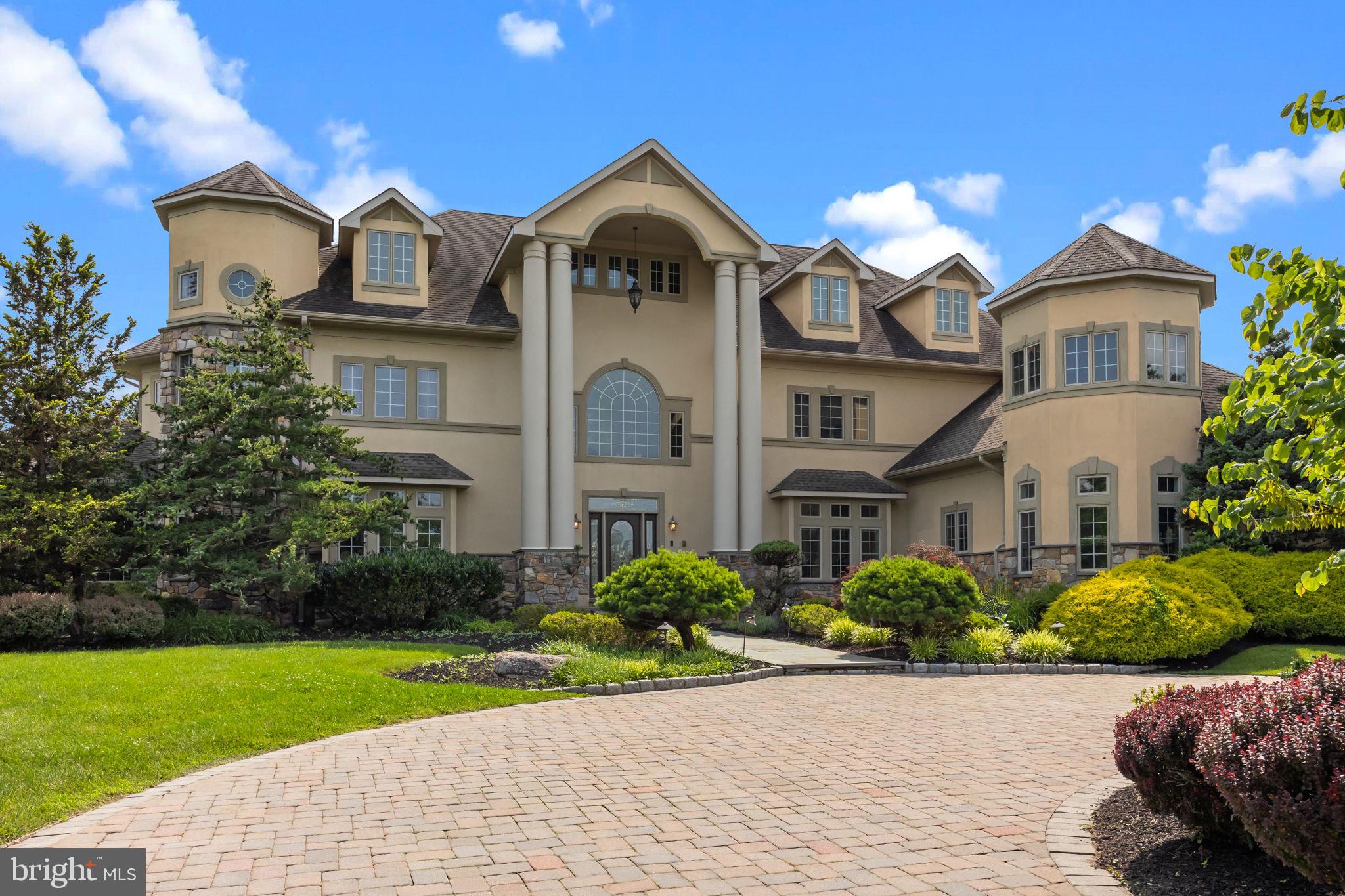 Welcome to the stunning 2 Aldans was in the sought after Council Rock School District. Step into timeless elegance and exceptional design in this expansive 5-bedroom, 6.5-bath residence offering four levels of meticulously crafted living space, a total of five garage spaces, and an outdoor retreat that rivals a private resort.

From the moment you enter, you're greeted by a dramatic dual curved staircase framing the two-story foyer, where a stunning chandelier and custom trim moldings make a striking first impression. Overhead, the open upstairs landing offers beautiful sightlines over the entry, setting the tone for the grandeur throughout the home.

The heart of the home is the upscale kitchen, featuring a wood-paneled refrigerator, large center island, gas cooktop, walk-in pantry, and butler’s pantry with a wine fridge. A built-in workstation with a desk adds functionality, while multiple dining areas—including a formal dining room, breakfast nook, and island seating—offer the perfect setting for everything from casual meals to elegant entertaining.

The sun-drenched two-story family room is anchored by a cozy fireplace and enhanced by a curved rail overlook above.  Nearby, a main-level office with custom built-ins provides the perfect work-from-home setup, and a separate flex room—ideal for a pool table or game room—features its own wet bar and leads down to the finished basement.

Upstairs, the luxurious primary suite offers a private retreat complete with a sitting area, dual vanities (each with 10 drawers and ample cabinetry), a spa-like soaking tub, custom tiled shower with bench and double shower heads, and a designer walk-in closet with built-in drawers and shelves.

The finished basement continues to impress with a wine tasting room, home theater, family room, wet bar, full bath, and a 6-person sauna. The top (attic) level offers three versatile flex spaces—perfect for game rooms, guest overflow, or a peaceful yoga studio.

Functionality meets thoughtful design in the rear entry hallway, which features a mudroom with built-in lockers, closet, and a spacious laundry room with pantry-style cabinets and a utility sink.

Outside, the professionally landscaped, fenced-in backyard is a showstopper. An in-ground pool with attached hot tub is surrounded by lush greenery, an expansive slate patio, and a covered lounging area beneath the upper-level deck. A charming gazebo houses a full outdoor kitchen, complete with grill, griddle, vented hood, mini fridge, ice maker, dishwasher, and bar seating—perfect for outdoor entertaining all year long.

With a 4-car detached garage and an additional 2-car detached garage, there's no shortage of space for vehicles, hobbies, or storage.

This exceptional property offers the perfect blend of luxury, comfort, and functionality—an entertainer’s dream and a true place to call home.