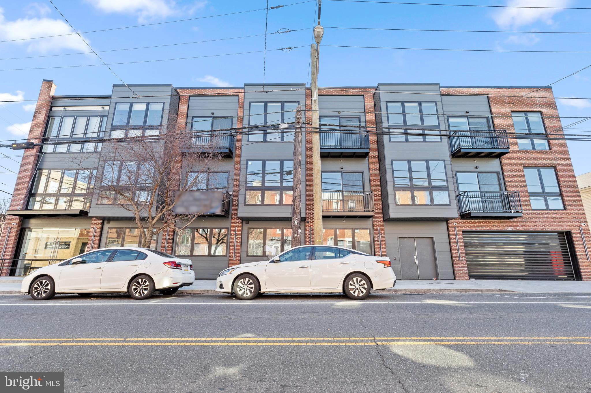 BRAND NEW LUXURY living in the heart of Queen Village! Enjoy the best of modern living in one of Philadelphia's most desirable neighborhoods at 300 Christian. Each airy and light-filled unit is thoughtfully laid out. As you enter, you're welcomed with floor to ceiling windows, high ceilings, in-unit stacked GE washer and dryer, great closet space, and high-end flooring throughout. The open concept living and dining room is perfect for entertaining and enjoy easy access to an outdoor patio. In the kitchen you'll find soft-close cabinets with a gleaming white finish, GE and Haier stainless steel appliances, dishwasher, plus gorgeous Dolomite Marble countertops. Off of the living space you'll find a comfortably-sized bedroom that offers ample storage and natural light, creating an inviting retreat. The bathroom continues with the same bright, fresh and clean aesthetic, featuring instant hot water and a roomy shower and tub for relaxing. This handsome pet-friendly building features a fitness center, secure mail room, onsite garage parking, bicycle parking, flex space, additional storage, elevator, and a communal roof deck with breathtaking city and garden views. All of these amenities combined with a great location make the residence at 300 Christian a wonderful place to call home. Enjoy being steps away from neighborhood favorites like Philadelphia Java Company, Shot Tower Coffee, Fitz on Fourth, Practice Yoga, Weccacoe Playground and Tennis Courts, Mario Lanza Park and Dog Run, easy access to I-95, public transportation, the expansive Delaware River Trail, and more. Welcome home! *Photos are of a model unit. Each unit has similar finishes.