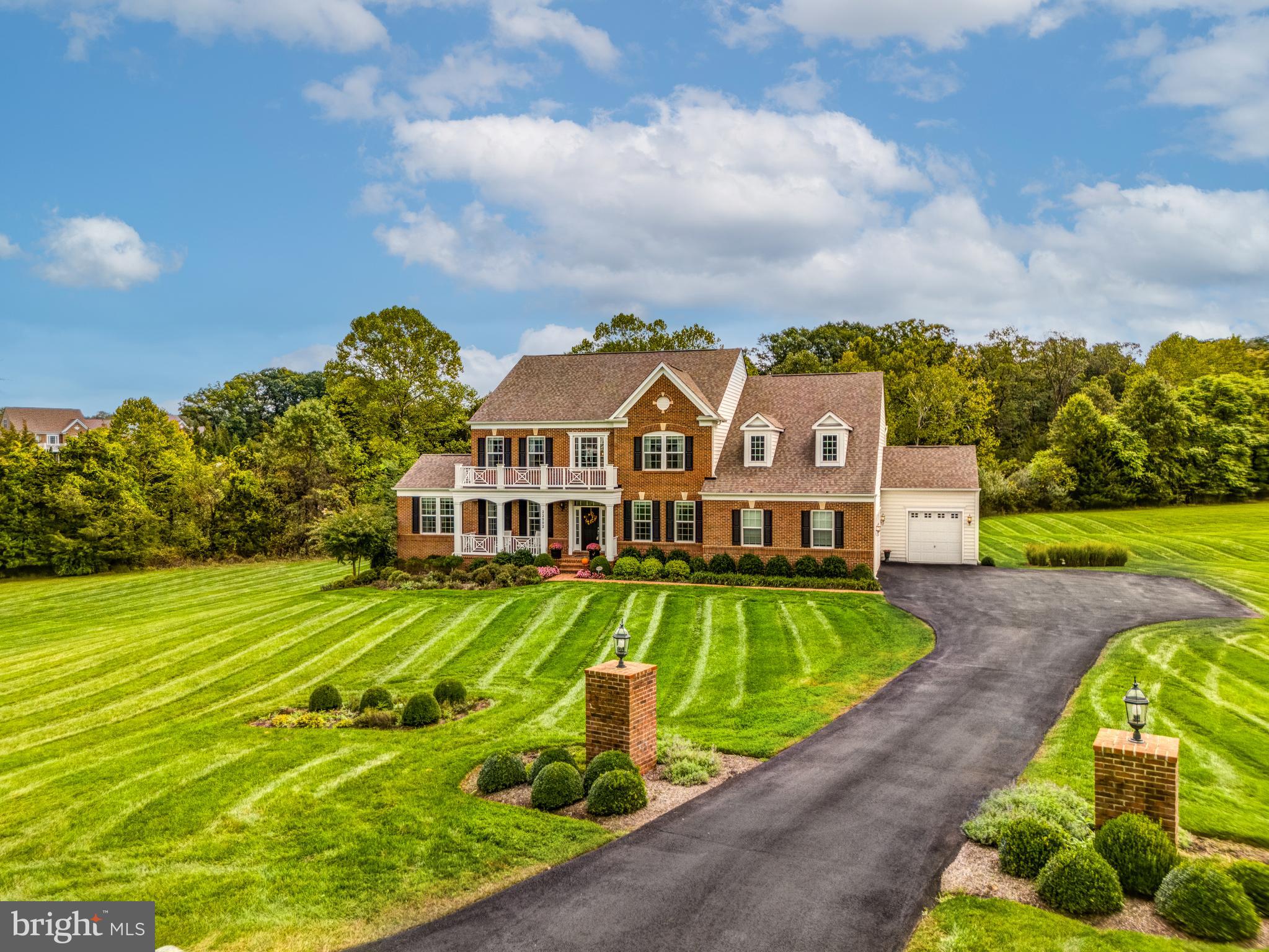 Set on almost 4 acres of wooded privacy in the exclusive Huntleigh at Creighton Farms neighborhood, this stunning professionally decorated “Colton” model offers 5 bedrooms and 4.5 bathrooms- over 6,600 sq ft of living space feet across three finished levels. The professionally landscaped yard features extensive hardscaping, custom stone accent walls, and accent lighting that casts a magical glow over the property at night. The spacious three-car garage with epoxy floors and custom racks provides ample room for oversized vehicles, bikes, outdoor gear, and more, ensuring convenience and practicality. This neighborhood is conveniently located across the street from Creighton Farms Golf Club. 

Upon entering, you're greeted by a grand oak hand stained staircase, fresh custom paint and hardwood floors throughout the first floor. The formal dining room connects to a convenient butler’s pantry, perfect for seamless entertaining. The living room opens to a bright and airy side sunroom, where large windows bring in natural light and offer picturesque views of the surrounding greenery, setting the tone for the home's timeless charm.

The heart of this home is undoubtable the gourmet kitchen, which opens to a delightful morning room, the perfect spot to enjoy a cup of coffee. The kitchen is equipped with top-of-the-line stainless steel appliances, a Wolf stove, double ovens, soft close cabinets and beautifully designed hood mantle. The large center quartz island, coffee bar and ample counter space make it perfect for meal prep and entertaining. Additionally, the home features an expansive walk-in pantry and a convenient mudroom area.

Relax in the welcoming family room, where a dual-sided fireplace exudes timeless elegance. The main level also includes a private home office, complete with custom built-in cabinets for added functionality and style.

Upstairs, the primary suite is a luxurious retreat featuring a tray ceiling, spacious sitting area, and a HUGE walk-in closet with custom built ins. The en-suite bathroom is designed with his and hers granite-topped vanities, a soaking tub, and a glass-framed shower with rain head. The upper level also includes three additional bedrooms-with new carpet. The Jack-and-Jill bathroom has upgraded quartz countertops, hardware and lighting. The third bedroom boasts its own en-suite upgraded bath as well as a walk-in closet A large walk-in laundry room with cabinetry and extra built-ins completes the upper level.

Need even more space? The fully finished walk-out lower level offers an ideal retreat for relaxation and entertainment. It features a large recreation room with hardwood flooring, a full wet bar equipped with sleek granite countertops, a refrigerator, kegerator, and sink—perfect for hosting gatherings. A dedicated home theater room with a 100-inch screen creates the ultimate movie night experience, while a game area, complete with a pool table, ensures endless fun. This level also includes the 5th bedroom or in-law suite, boasting a spacious walk-in closet and a full bathroom. Natural light pours in through three large sliding glass doors, which provide direct access to the backyard for seamless indoor-outdoor living.

The backyard is truly an oasis designed for ultimate relaxation and entertainment, featuring a spacious Trex deck that overlooks an 1400 sq. ft. covered paver patio equipped with an outdoor TV. Host unforgettable barbecues in the fully equipped outdoor kitchen, complete with sleek granite

countertops and a built-in Blaze grill. The stone wood burning fireplace adds a cozy touch, allowing for year-round enjoyment, whether it’s al fresco dining or quiet evenings under the stars. Seller has Virginia real estate license.