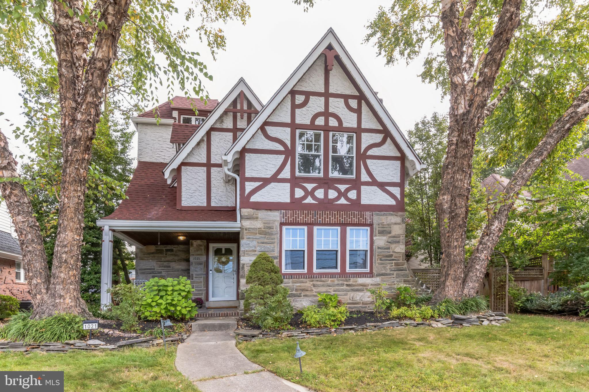 Discover the allure of this exquisite four-bedroom, three-and-a-half-bathroom Tudor home nestled on a tree-lined street in the highly sought-after Aronimink section of Drexel Hill. Upon arrival, a concrete walkway leads you through vibrant front gardens to a custom stone front patio, setting the stage for the captivating elegance within.

As you enter the home, the main level boasts an expansive family room to the right, featuring a substantial stone, gas fireplace with a wooden mantle and brick hearth, hardwood flooring, tasteful crown molding, and chair railing. This space seamlessly flows into a second living area with plenty of space to accommodate a formal dining room, creating an inviting atmosphere for gatherings.

The gourmet chef’s kitchen awaits, complete with stainless steel appliances, sparkling granite countertops, a plethora of wooden cabinetry, masterfully crafted backsplash tiling, a vast pantry, recessed lighting, and a spacious breakfast area. Nestled in the rear of the home is a bright and airy living room adorned with oversized windows, hardwood flooring, and convenient access to the rear yard and the decoratively tiled powder room.

Ascend the front wooden staircase to discover the primary suite, featuring hardwood flooring, an abundance of natural light, and an ensuite bath with tiled flooring and a stall shower. Three additional newer carpeted bedrooms on this level , gleaming hardwood flooring throughout the hallway and ample closet space, sharing a full-hall bathroom.

The third floor features an enormous loft area with a built-in bookcase and convenient privacy door access to a large unfinished space. This versatile area could be transformed into additional living space or utilized for excellent storage options. The partially finished lower level provides a customizable space tailored to the buyer's preferences. It encompasses a play area, a private office, and an in-home gym space, along with a full bathroom and a wooden workbench.


Step outside to the rear yard, where a custom brick porch awaits for entertaining, surrounded by yards of rolling green grass, discerning wooden fencing, an attached shed, and two-car parking in the driveway. The property has recently undergone a series of upgrades and renovations, including a full replacement of the roof and gutter/guard system, installation of a new water heater, addition of basement hookups for a washer and dryer, an upgrade to the electric service, and a complete rewiring of the home's electrical system.

Experience the convenience of being within walking distance to bars, breweries, the trolley, various dining options including food, coffee, and ice-cream shops, as well as the upgraded playground at the elementary school across the street. Additionally, all essential amenities, such as grocery stores, gas stations, restaurants, household goods, and shopping, are within a 5-minute drive, making everyday errands a breeze.

This remarkable home offers an exceptional blend of classic elegance, modern amenities, and a desirable location, presenting a rare opportunity for refined living in Drexel Hill.