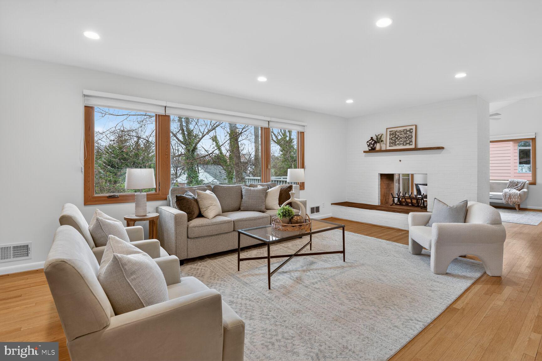 Now offered at an improved price, this beautifully renovated Mid-Century Modern home in Kenwood Park offers an exceptional blend of warmth, natural light, and modern convenience. Thoughtful updates are found throughout, including Leicht German cabinetry and Caesarstone countertops in the kitchen and bathrooms.

The kitchen is both stylish and functional, featuring excellent storage, upgraded appliances, and direct access to the two-car carport. A striking two-sided wood-burning fireplace anchors the main living spaces, adding warmth and character to both the living room and the vaulted-ceiling den.

The den opens to a spacious deck with stairs leading to a flagstone patio and fire pit—ideal for entertaining or relaxing outdoors—and may also serve as an elegant formal dining room. The main level includes four bedrooms and two full bathrooms, providing comfortable and convenient living.

The walk-out lower level offers remarkable flexibility with a large recreation room centered around a second wood-burning fireplace and sliding doors to the patio. A versatile kitchenette/craft room—complete with an additional refrigerator, freezer, and full-size washer and dryer—creates space for hobbies, entertaining, or multigenerational living. This level also features a second den, a third full bathroom, and a fifth bedroom, perfect for guests, a private office, or a home gym.

Timeless Mid-Century design, inviting indoor-outdoor spaces, and modern functionality come together beautifully in this exceptional home.