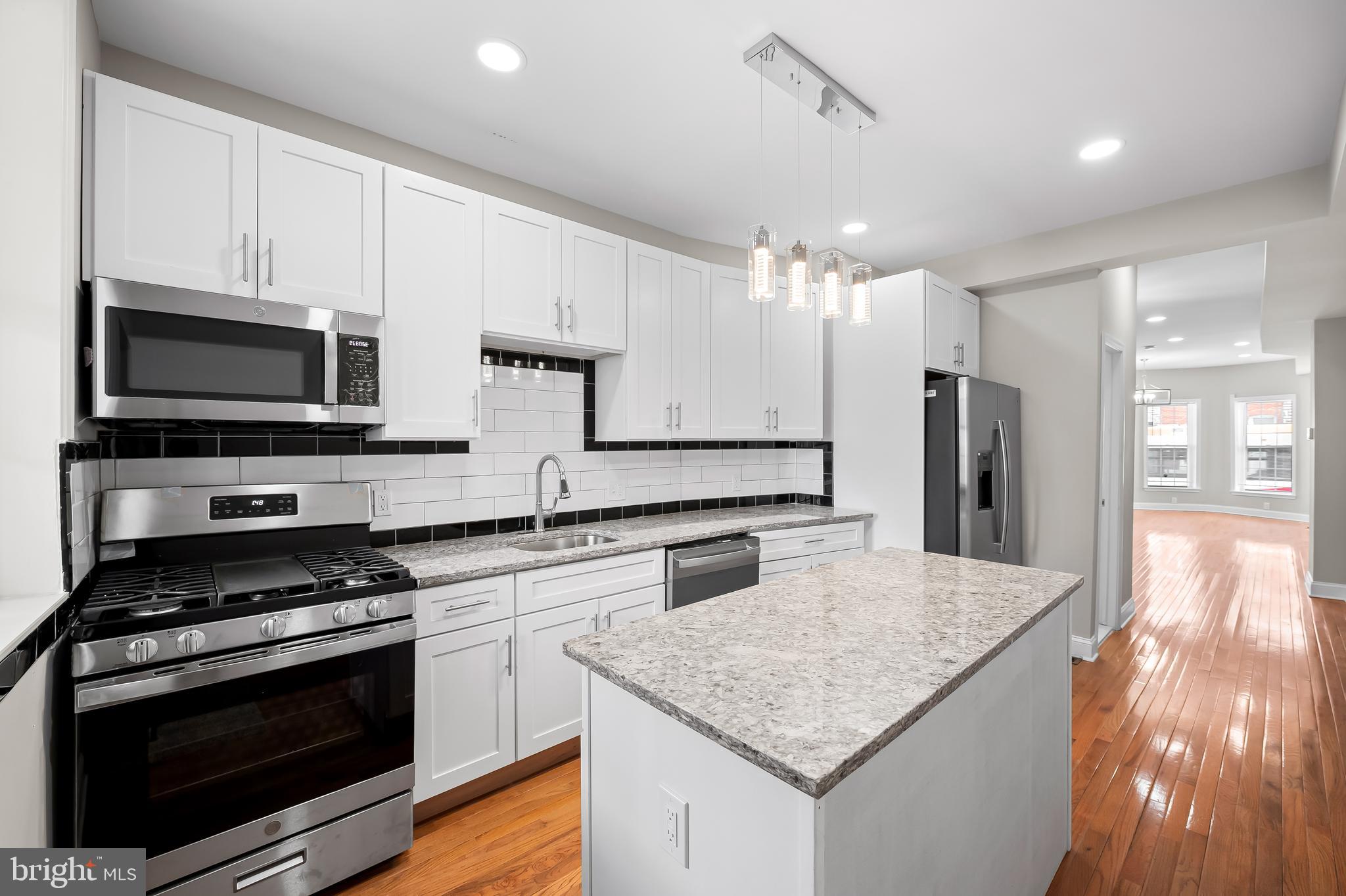 Don’t miss out on this gorgeous, newly renovated home on a block with multiple other homes getting redone (including next door). Featuring 3 bedrooms, 3 full bathrooms, and 1 main level powder room this home is a dream with over 1800 square feet of finished living space. Located walking distance to Johns Hopkins Hospital in the thriving Middle East neighborhood,  this home is in a great location, and near Patterson Park if you like lots of green space. 

The main level is an enormous open living room and dining room that can be designed numerous ways to suit your style. Brand new hardwood greets all your guests and flows from your warm entryway, with a lovely bay window front, all the way through to your kitchen in the rear of your home. Soaring ceiling height adds to the feel of this bright inviting home. Recess lights and tasteful chandeliers add to the sophistication that you’ll find here. The kitchen is decked out with 42” upper cabinets, Stainless Steel appliances and a large prep island all capped with shining granite countertops. Open your rear door to a fenced in private oasis where you’ll enjoy shade from the tree next door and grill in all weather, covered under your rear back covered porch. 

The upper level of your new home offers 3 large bedrooms all with windows to let in the sunshine and fresh air on nice days. The front bedroom is your primary suite with a private bath and rounded front bump out, a rare feature found in just a few homes on this block. The middle bedroom is just across the hall and would be easy access in the middle of the night if used as a nursery. It is also hardwood and could be a beautiful spot for a home office or reading room. Bedroom 3 is down the hall and more private, overlooking the backyard area. Front and rear bedrooms offer plush carpet and a fashionable ceiling fan accents your primary suite. 

The lower level of 738 N. Patterson Park is fully finished, which is a huge deal for Baltimore rowhomes. The ceilings are high and you’ll enjoy luxury vinyl plank flooring from front to rear. Under the stair space is used smartly and is home to the mechanicals for your home- central HVAC, gas hot water heater and sump pump. Towards the middle back you’ll have your 3rd full bathroom, making this a  great area to incorporate a guest bedroom. There is an exit to the back yard as well. The rear room will be home to your laundry area and extra storage. 
Across the street to the North you’ll find the Henderson-Hopkins Elementary school with its new Athletic Field that keeps a great look to the block. Madison Avenue to the South is a bustling commerce area with all types of shopping and restaurants and it is easy access to public transportation. First time home buyers be sure to check into or ask more about the multiple home ownership grants that you could take advantage of and make home ownership even more achievable.
