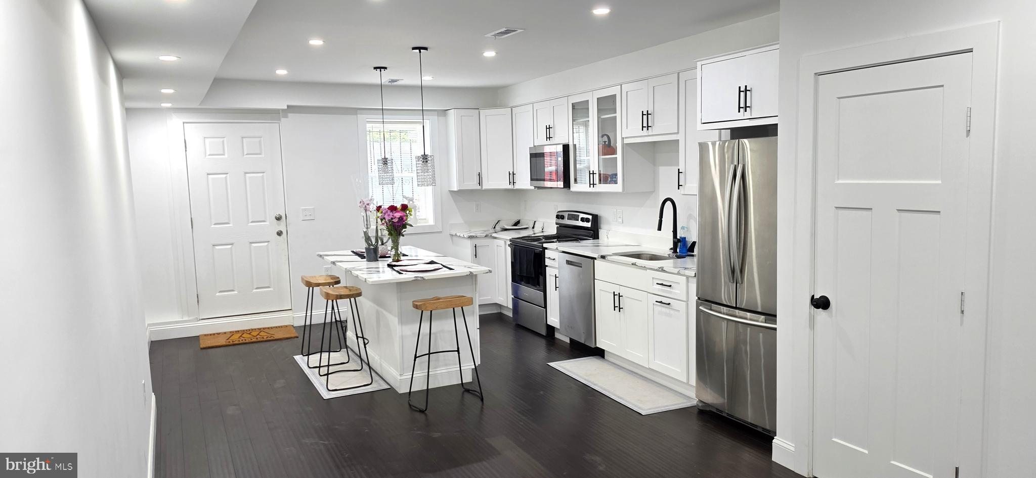 Nestled in the charming Broadway East neighborhood, this exquisite end-of-row townhouse seamlessly blends contemporary design with timeless elegance. With a major renovation completed in 2026, this home offers a luxurious lifestyle that caters to both comfort and sophistication. Step inside to discover an inviting open floor plan that effortlessly connects the living, dining, and kitchen areas. The heart of the home features upgraded countertops and a spacious kitchen island, perfect for culinary enthusiasts and entertaining guests. The eat-in kitchen is adorned with high-end appliances, including a built-in microwave, electric oven/range, and a sleek refrigerator, ensuring every meal is a delight. Recessed lighting and ceiling fans enhance the ambiance, while the rich wood floors and ceramic tile add warmth and character throughout. This residence boasts four generously sized bedrooms, providing ample space for relaxation and personalization. The three full bathrooms and one half-bath are designed with modern fixtures and finishes, offering both style and functionality. The main floor laundry adds convenience to your daily routine, making chores a breeze. Venture downstairs to the partially finished basement, which offers endless possibilities for customization-whether as a cozy retreat, a home gym, or additional storage. The interior access and connecting stairway ensure easy movement throughout the home. Outside, the property is framed by charming sidewalks, inviting you to explore the vibrant community. While there is no pool, the low-maintenance lot size of 0.03 acres allows for easy outdoor enjoyment without the burden of extensive upkeep. On-street parking provides convenience for you and your guests. With double-pane insulated windows, this home is designed for energy efficiency, ensuring comfort year-round. The combination of brick and aluminum siding not only enhances the exterior aesthetic but also promises durability and low maintenance. This property is more than just a house; it's a lifestyle choice that offers a perfect blend of luxury, comfort, and community. Experience the best of contemporary living in a home that truly feels like a sanctuary. Don't miss the opportunity to make this exceptional residence your own.