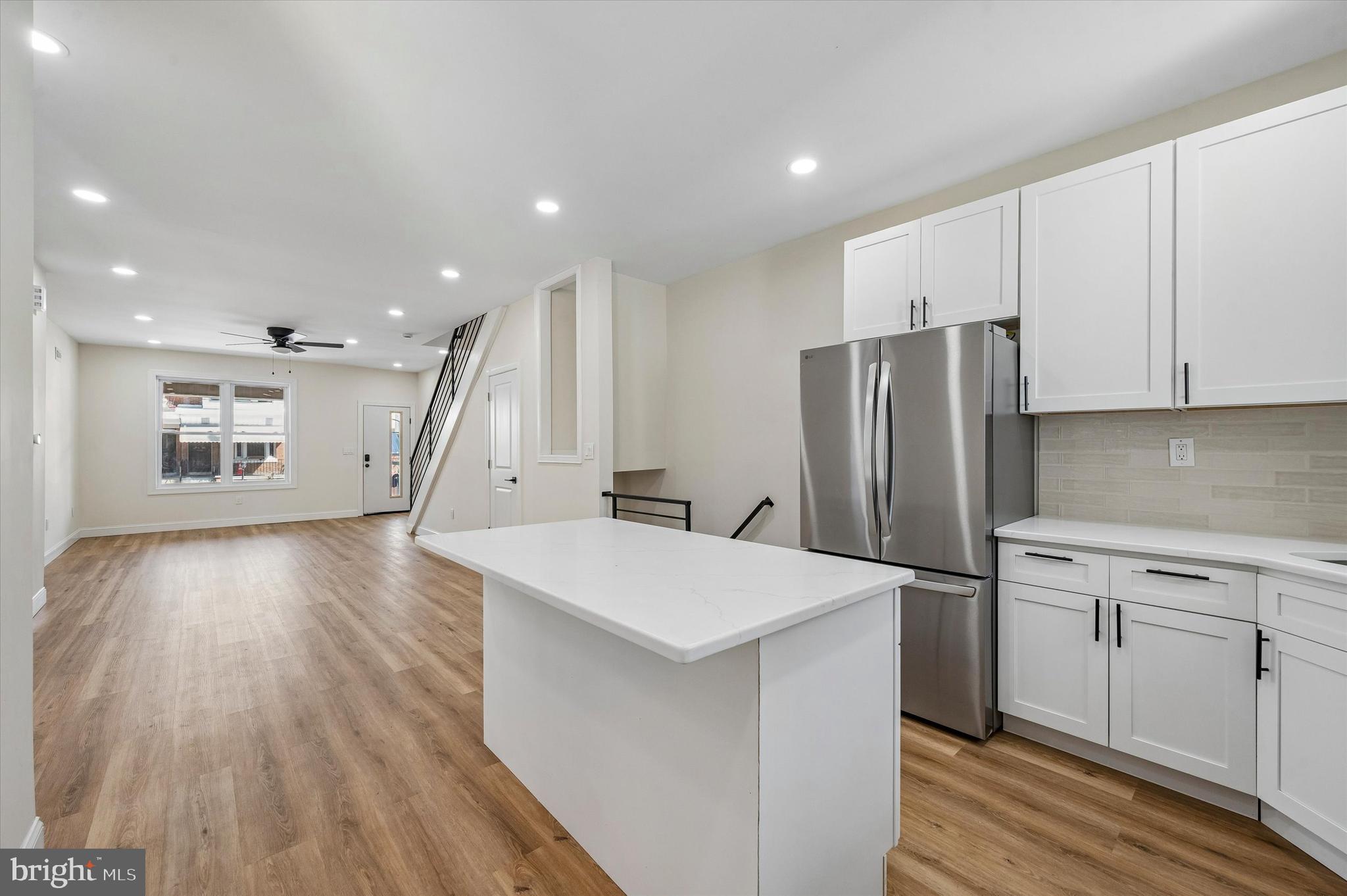 Discover a beautifully updated 3 bedroom, 3 bathroom residence that blends classic charm with thoughtful modern touches in a vibrant Philadelphia community. Step inside to an inviting living room enhanced by recessed lighting and a ceiling fan that creates a bright comfortable atmosphere. The main level also features a convenient powder room for guests. The kitchen is a chef’s delight with crisp white shaker cabinets, subway tile backsplash, and a versatile island with seating and extra storage. Appliances include a refrigerator, dishwasher, and gas cooking, while convenient laundry hookups are also on the main level with direct access to the fully fenced backyard, perfect for outdoor gatherings and relaxation. The lower level offers a fully finished basement complete with a full bath and shower stall, providing flexible living space ideal for recreation, media use, or a guest suite. Upstairs you will find three well sized bedrooms each with ceiling fans and ample closet space complemented by sleek laminated flooring and recessed lighting throughout. A hallway bath with tub and shower serves the upper level. This property is located in a neighborhood known for its strong sense of community and convenient access to public transportation, shopping, dining, and parks. It offers a wonderful opportunity to enjoy all that city living has to offer while still having a peaceful private retreat to call home.