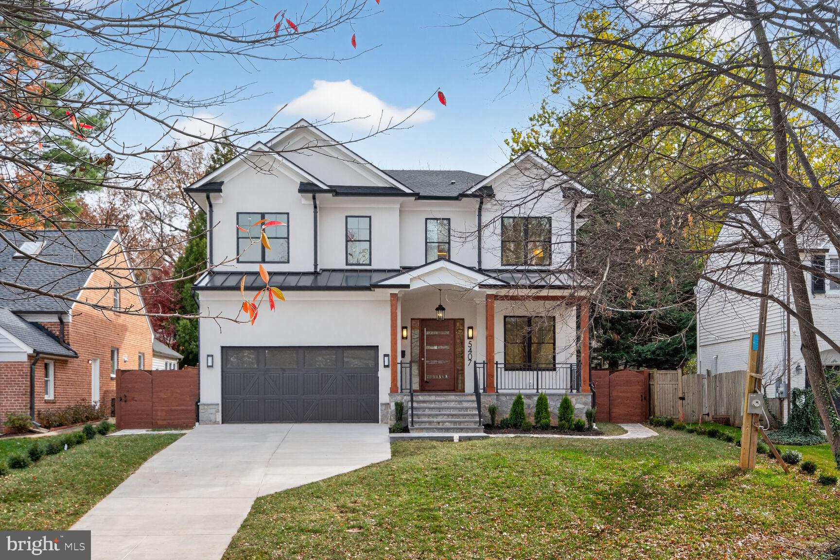 New Construction Elegance in Chevy Chase Village, steps to METRO in one of the most desirable neighborhoods in Montgomery County.  A collaborative developed property with local Builder Center Pointe Homes, CLAUDE C. LAPP ARCHITECTS and CAS Engineering provides the new owner a six-bed room six full bath residence with 5400 sq ft of living space.

Sited on a promontory, the property is enveloped in natural Arctic white stucco, with raised arched ceiling front covered porch with solid cedar posts. All black Pelle clad windows were the fenestration choice for the home which offset nicely.  The rare two car garage offers 500 sq ft for vehicles, and storage; driveway has space for an additional four cars. The fresh carpet of green space is accentuated with boxwood boundaries and a privacy fence.

The front entrance is a custom mahogany pivot security door with a full open width of four feet with side lights.  You enter into a large foyer, with sitting or living room and open connections to the large dining pavilion.  Bespoke cabinetry and plank cedar floating shelves define the space hewn from a tree harvested from the property.

The entire first floor is a public living space with defined function.  Nine -foot ceilings, and herringbone oak floors lead to the central open stairway with cube treads and spindle balustrades. The central living / family room is the focal gathering space. A linear gas fireplace and mantle, and a wall of foldable nano-doors that lead to the screened in bluestone porch, patio and lush green rear yard with arbor vitae surrounding trees on one perimeter.
To the right is the bespoke kitchen with built to space all wood stacked cabinetry, a 48-inch Wolf dual fuel oven, Cove and Sub-Zero refrigeration, and Bosch wall oven and convection microwave, in stainless and panel ready design. An undermount ceramic cast farmers sink sits in the natural stained cabinets of the island. Connected is the butler pantry with wine fridge and additional offset natural wood cabinetry. The entire kitchen space is surfaced in in quartz-stone which adds warmth to the elegance of the space.

A first-floor office that connects to a full bath making it convenient for guests, and doubles as a first-floor bedroom. The bath is natural marble and mosaic with a custom marble floating sink. Adjacent is the mudroom with pantry space, sink, seating and cubbies for coats and supplies with a seating space and storage for shoes. The central stairs lead to the bedroom level. Three bedrooms all with ensuite baths surround the front of the house. Equally appointed but unique, features include Carrera marble, custom furniture grade cabinetry and floating cabinets with clean porcelain finishes.  The hall also has a separate linen closet and full laundry room featuring hanging cabinetry, sink, with folding counter and a window.

The Primary suite is an oasis with two custom built-in closets with hanging space, drawers and custom lighting. Next the primary bath all in white marble mosaic, large format marble flooring, bespoke wood vanities, a massive shower with frameless glass and a six-foot pedestal soaking tub. Separated vanities, timeless chrome hardware and a make-up space a siting level as well as two pantry sized storage space and a built-in linen closet. The commode is an egg design with self-flushing and bidet features. Folding doors lead to an outdoor deck that provide a quiet outside space for relaxation.

The lower level is a dream entertaining space; built-in cabinets, sink, microwave, exterior steps the rear yard. There is a bedroom with connected bath, an exercise room (or second bedroom) and a third storage room that would make and excellent sauna or wine storage.

Bespoke features include zoned infinity Carrier dual stage furnace and AC systems, built in blue tooth speakers, dual tankless gas instant hot-water systems, closed foam insulation through-out. Walkable to metro, and adjacent to the District of Columbia. A home for a lifetime.
