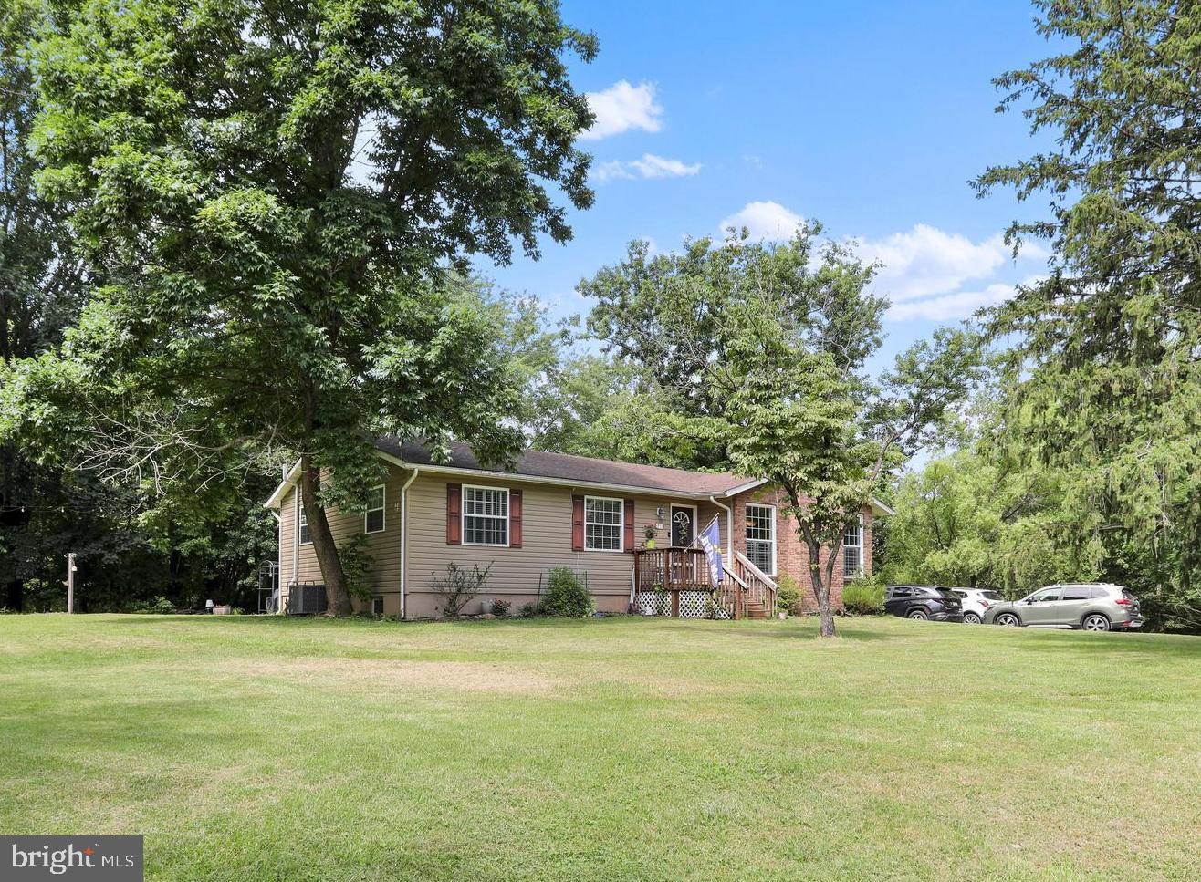 Tucked into a peaceful, wooded setting with flat, usable yard space, this spacious mountain ranch-style home offers the perfect blend of comfort, charm, and versatility, with over 2,500 square feet of finished living space and priced below appraised market value. The main level features a large primary bedroom with a private ensuite bath, along with two additional bedrooms and another hallway bathroom. The heart of the home features a cozy living room with a gas fireplace and an inviting kitchen equipped with a gas stove, ample cabinet storage, a spacious pantry, and a sliding barn door for added character. Just off the main living area is an incredible sunroom with a pellet stove for the colder months and a ceiling fan to keep things breezy in the summer, making it an ideal year-round retreat. <br><br>

The fully finished basement offers impressive additional living space and even the potential for a bedroom setup. It features a spacious rec room with a pool table that conveys, a wet bar, full-size fridge and freezer, and a cozy woodstove for those chilly winter nights. There’s also a laundry area with a utility sink and convenient walk-up access to the backyard. Step outside to a flat, open space perfect for entertaining, and don’t miss the private hot tub nestled on its own deck, seamlessly integrated into the landscape for ultimate relaxation.
 <br><br>

The house is serviced by public water, and a recent septic inspection and pumping were completed in June 2025. Additionally, the property features propane gas, high-speed Xfinity internet, and multiple storage sheds that are included in the sale. It is ready for modern living in a mountain setting. Whether you’re entertaining, relaxing, or working from home, this thoughtfully designed property has the space, updates, and setting to make it all possible. Don’t miss your chance to own a beautiful mountain retreat with serious style and substance. <br><br>