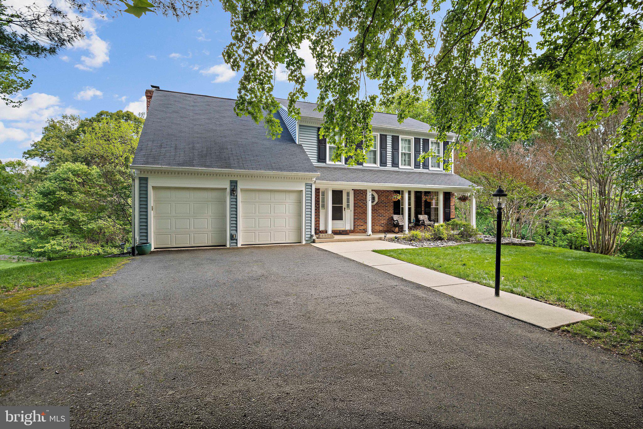 Welcome to 9830 Faust Drive in Vienna's Wolftrap Meadows. This beautiful traditional Colonial is nestled on a pristine one-acre lot backing to a lush conservation area, offering a rare level of privacy and tranquility.

Designed for both entertaining and comfort, the main level features hardwoods, custom plantation shutters, and a seamless flow. A unique billiards room sits off the foyer, leading to a formal dining area with French doors opening to the deck. The chef’s kitchen, anchored by an enormous granite island, truly defines open-concept living, flowing effortlessly into a soaring two-story family room centered by a magnificent stone floor-to-ceiling fireplace facade and bright skylights.

The true highlight of this home is the expansive, climate-controlled four-season sunroom. Accessed via French doors from both the kitchen and family room for a seamless transition, this spectacular addition dramatically increases the main-level living space. The sunroom’s flexible footprint easily accommodates multiple social layouts—including distinct dining, lounging, and conversation areas—all set against a panoramic wooded backdrop.

The second story features a primary suite and two additional spacious bedrooms. The versatile loft/flex space overlooks the family room below; currently used as a home office, it offers the footprint and walk-in closet to be easily enclosed for a private fourth upper-level bedroom.

The bright, walk-out basement includes a recreation room, guest bedroom, full bath, and large laundry room. Step outside to the large brick patio to enjoy breathtaking views of the sprawling lot. 

Additional highlights include its prime location within the desirable Westbriar, Kilmer, and Marshall school pyramid and its proximity to the Fairfax County Cross County Trail, which seamlessly connects to the W&OD trails for outdoor enthusiasts. This home offers the perfect balance of seclusion and convenience with quick access to the Dulles Toll Road, Leesburg Pike, and Rt 123.
