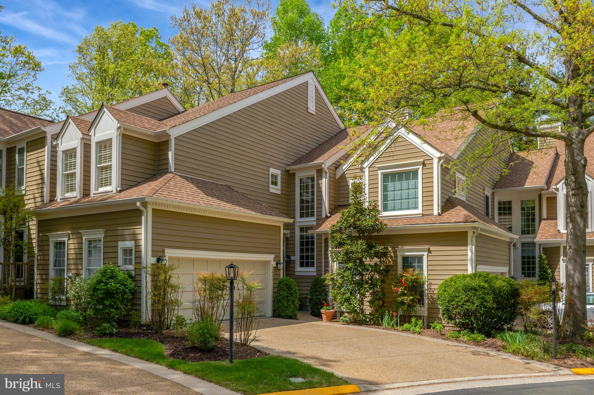 Welcome to 11431 Hollow Timber Way, a beautifully maintained 3-bedroom, 3.5-bath townhome with a 2-car garage, located in Timberview Cluster—one of Reston’s most desirable neighborhoods. This unique Z lot line property offers the privacy and ambiance of a single-family home, backing to mature trees and peaceful green space.

Step inside to a dramatic two-story foyer and living room, where a wood-burning fireplace and expansive windows fill the space with warmth and natural light. From here, enjoy seamless access to a private deck with wooded views. The kitchen features granite countertops, stainless steel appliances, and generous cabinet storage. A formal dining room provides the perfect setting for gatherings, and a powder room completes the main level.

Upstairs, you’ll find two spacious bedrooms, each with its own ensuite bath. The primary suite includes a large walk-in closet, stall shower, soaking tub, and tranquil views of the trees. The secondary bedroom offers two closets and its own full bath. A bright, open loft provides flexible space—ideal for a home office, reading nook, or creative retreat. The conveniently located laundry room is also on this level.
The walk-out lower level features a spacious recreation room with a second wood-burning fireplace, a third bedroom, a full bathroom, and a large storage area. Step outside to a charming brick patio—perfect for relaxing or entertaining outdoors.
Beautiful hardwood floors run throughout all three levels, and most windows are outfitted with custom shutters. Key Updates include: Water Heater -2025, Interior Painted- 2024, Appliances- 2023, Roof/Gutters & DownSpouts- 2014.
Enjoy all the benefits of Reston living, with easy access to North Point Village Center, North Hills Pool and Tennis, and miles of wooded trails. You’re just minutes from Reston Town Center, the Silver Line Metro, Lake Anne Plaza, and major commuter routes—with quick access to Dulles Airport, Tyson's Corner, and so much more.
