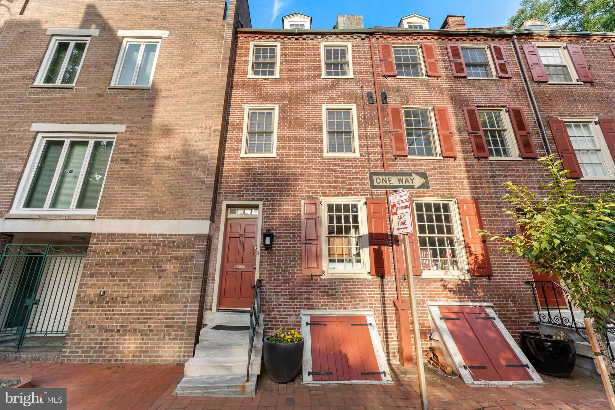 Tucked away on one of Society Hill's most picturesque cobblestone mews, 327 Lawrence Court offers a rare opportunity to own a piece of Philadelphia history in an extraordinary setting.

One of only four surviving and expanded trinity homes incorporated into the celebrated Lawrence Court redevelopment, this residence bridges two eras of Society Hill's evolution: the neighborhood's original 19th-century residential fabric and the acclaimed urban renewal vision that transformed the area into one of America's most admired historic neighborhoods.

Set behind a classic brick façade with traditional shutters, the home opens to a surprisingly spacious interior spanning approximately 1,400 square feet across four levels. Hardwood floors run throughout much of the home, while oversized windows fill the living spaces with natural light and provide peaceful views of the surrounding trees, gardens, and cobblestone streetscape.

The main living level offers an inviting open-concept layout with generous ceiling heights, custom built-in shelving, and a seamless flow between living and dining spaces. Just a few steps above, the kitchen features warm wood cabinetry, stone countertops, stainless steel appliances, abundant storage, and a convenient counter overlooking the living area.

The 2nd and 3rd floors have similar layouts with a bedroom, full bathroom and an additional small bedroom. The top floor retains the charm and character of the home's historic roots, featuring exposed wide-plank flooring and architectural details that evoke the building's 19th-century origins. This attic floor would great as an office or playroom space.

One of the property's most special features is its private rear garden. Framed by mature landscaping, flowering hydrangeas, brick walls, and a canopy of trees, the courtyard creates a quiet retreat rarely found in Center City. Whether enjoying morning coffee, gardening, or entertaining guests, the outdoor space feels worlds away from the city while remaining just steps from everything Society Hill has to offer.

Lawrence Court itself is among Philadelphia's hidden gems—a tree-lined cobblestone mews known for its remarkable sense of privacy, architectural character, and community atmosphere. Residents enjoy immediate access to Headhouse Square, Washington Square, Penn's Landing, Independence National Historical Park, acclaimed restaurants, neighborhood markets, and some of the city's most beloved streets.

For buyers seeking something beyond the ordinary, 327 Lawrence Court offers a unique combination of history, charm, outdoor space, and an irreplaceable Society Hill setting.