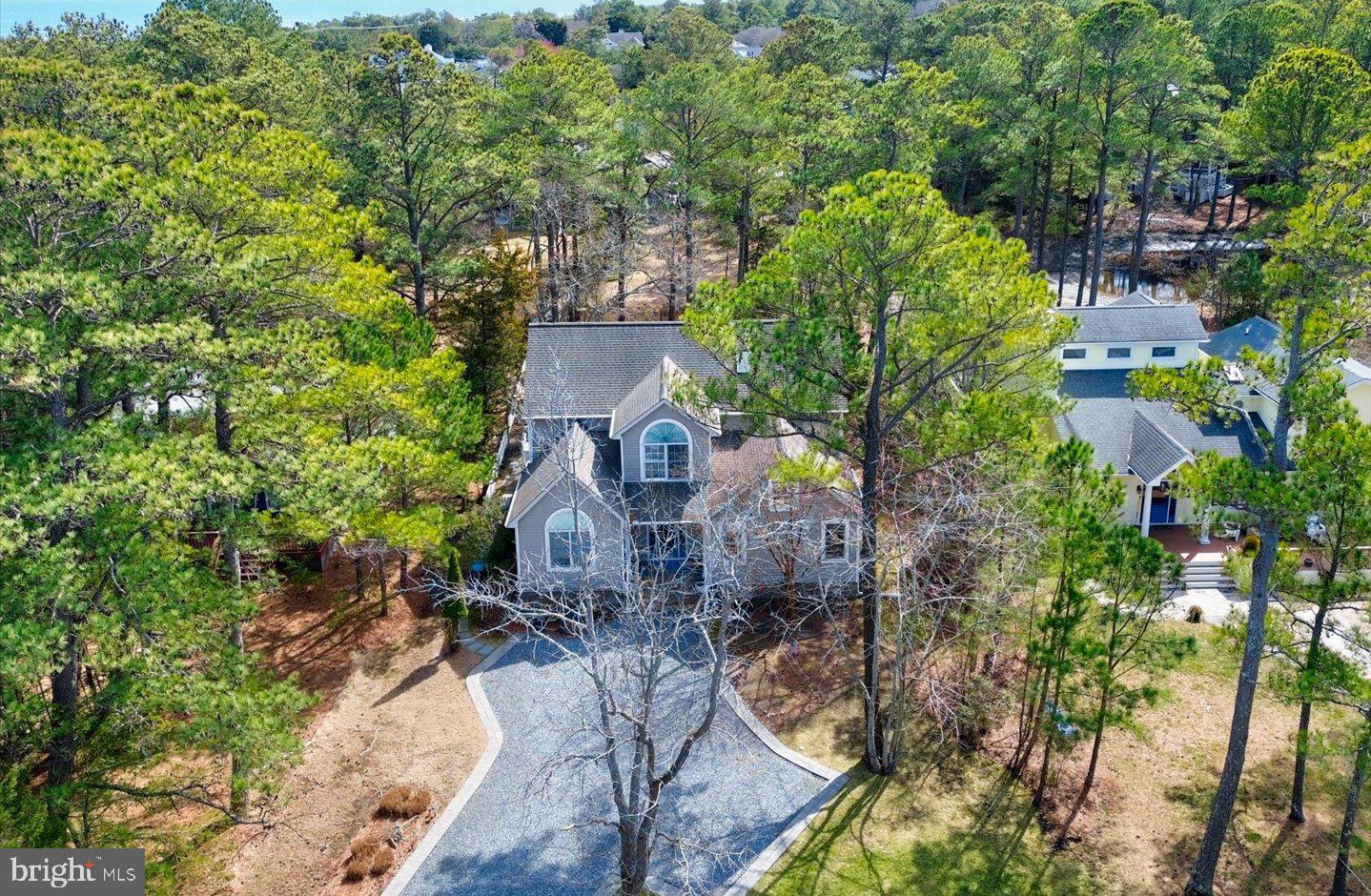 Nestled in the prestigious North Shores community, this beautifully maintained  home offers an inviting blend of timeless charm and modern elegance. Thoughtfully furnished and tastefully updated in 2022-2024, this spacious home boasts 5 bedrooms and 3.5 baths, including two primary suites, one conveniently located on the first level and a second, more expansive suite on the upper level. The popular open-concept floor plan is perfect for relaxed coastal living, featuring a welcoming family room with a gas fireplace framed by a stunning stone surround. The adjacent kitchen is a chef’s delight, complete with stainless steel appliances, a large breakfast bar, and easy access to the oversized sun deck and screened porch—the ideal setting for outdoor entertaining. A separate den on the first floor provides flexible space for a home office, movie room, or music room. Upstairs, three cozy guest bedrooms share a well-appointed hall bath, while the second primary suite offers a true retreat, complete with a private sitting room, a custom walk-in closet, and a spa-inspired bath featuring a double vanity, jetted soaking tub, and a tiled walk-in shower. Situated on a generous lot surrounded by mature trees, this home enjoys a large front yard and a fully fenced rear yard perfect for a future pool, providing both privacy and space to enjoy the outdoors. This home also features an outdoor shower and storage shed that has been grandfathered in, perfect for bikes and beach gear. As part of the exclusive North Shores community, residents benefit from a private beach, pool, marina, tennis courts, and 24/7 security. Additionally, this exceptional location places you just moments from Gordon’s Pond and the vibrant shops and dining of downtown Rehoboth Beach. Experience the best of coastal living in this rare North Shores offering!
