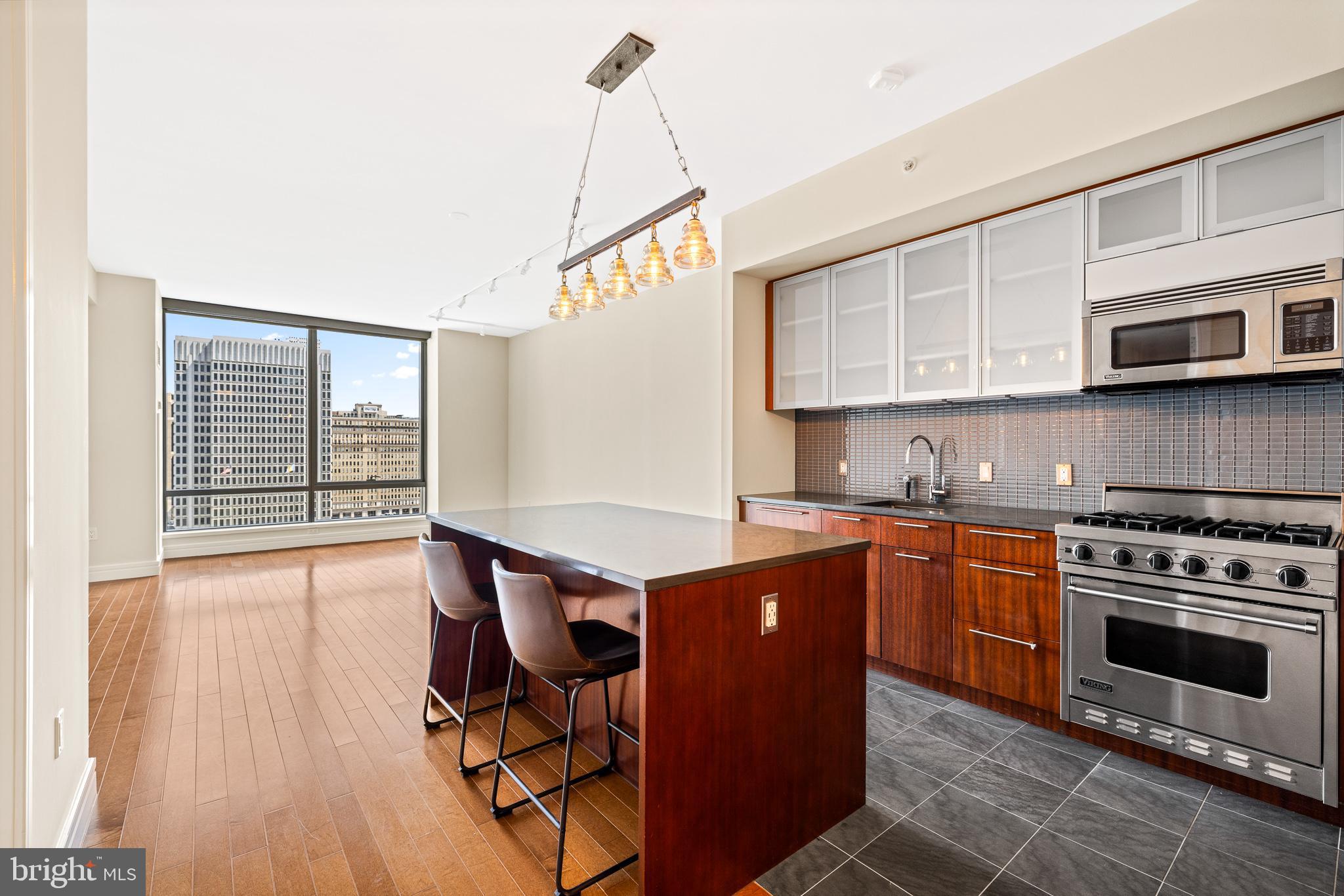 INCLUDES ACCESS TO A LUXURY COURTESY CAR & DRIVER! -  Discover the epitome of luxury city living in this extraordinary 1-bedroom, 1.5-bath residence at The Ritz-Carlton Residences. Positioned high above the city, this home offers floor-to-ceiling windows with sweeping views, where the iconic City Hall serves as the focal point and 9' ceilings.  The open kitchen features custom wood cabinetry, granite countertops, and top-tier appliances. The Calacatta marble primary bath includes a double vanity, seamless glass-enclosed shower, and a luxurious Bain Ultra soaking tub. Custom-fitted closets throughout add function and style. Residents enjoy access to an unmatched suite of amenities, including a luxury courtesy car and driver, and newly renovated terrace which includes multiple outdoor grills & dining areas and several outdoor lounge areas with fire-pits and much more, state-of-the-art fitness center, wellness room, and indoor pool & hot tub.  A brand new outdoor dog park offers a secure space for pets to play,  The recently redesigned resident lounge, private screening room, and catering kitchen redefine in-building luxury living. With direct access to the adjacent Ritz-Carlton Hotel through a private resident entrance, enjoy hotel dining, the spa, and even room service at your doorstep. This is a rare chance to own one of the city’s most refined residences, complete with every convenience at your fingertips.  -  Some photos staged furnishings. PARKING IS AVAILABLE - CONTACT AGENT FOR DETAILS.