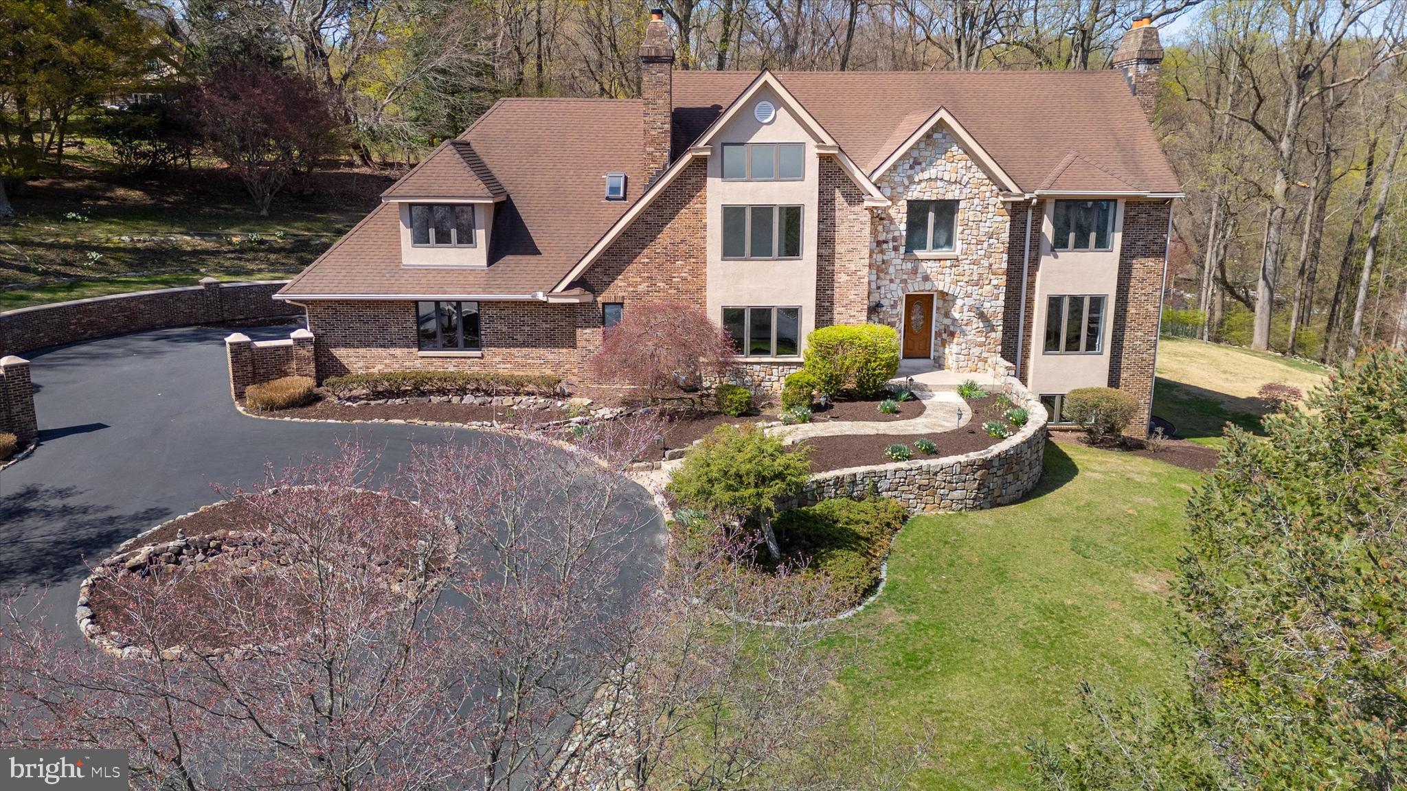 411 Hidden Valley Road | A Private Estate in the Heart of Media
Tucked away at the end of a secluded cul-de-sac, just minutes from the charming shops and dining of Media Borough, this exceptional estate offers a rare blend of privacy, elegance, and convenience. Set on 1.3 acres of beautifully landscaped grounds, this stately residence boasts 5 bedrooms, 3 full baths, and 3 half baths across 5,630 square feet and has been thoughtfully updated.  From the moment you arrive, refined details and timeless design make a lasting impression. A circular driveway and three-car garage provide an elegant welcome, while lush, manicured gardens enhance the home’s tranquil setting. Inside, newly refinished site-finished hardwood floors, newly installed LED recessed lighting through out the home and three fully renovated bathrooms reflect a sophisticated update to this classic home.A dramatic curved staircase anchors the grand foyer, setting the tone for the stylish interiors beyond. The first floor features two expansive living areas—one, a formal entertaining space centered around a wood-burning fireplace, and the other, a cozy family room perfect for everyday relaxation.At the heart of the home is a gourmet kitchen designed for both function and beauty, offering a generous center island, granite countertops, stainless steel appliances, and custom cabinetry. Open sightlines connect the kitchen to the family and dining rooms, making it ideal for both intimate gatherings and grand-scale entertaining. Adjacent to the kitchen, a butler’s pantry, spacious laundry room, second powder room, and rear staircase add convenience and character.Upstairs, five well-appointed bedrooms provide plenty of space for family and guests, with the flexibility for a sixth bedroom or dedicated home office. Each room offers ample closet space, while the newly renovated bathrooms evoke a spa-like experience with custom tilework and high-end fixtures. The luxurious primary suite features a walk-in closet, two additional closets, and a linen closet. The showstopping ensuite bath is designed to impress, with a soaking tub, custom-tiled shower, and a sleek white oak vanity.The fully finished lower level expands the home’s living space with new luxury vinyl plank flooring, oversized windows, and a powder room. Whether used as a home gym, media room, studio, or creative workspace, this sun-filled space offers endless flexibility.Outdoors, enjoy summer entertaining on the private back patio, or simply unwind in the serenity of your expansive yard. Every inch of the property reflects care and craftsmanship, creating a true sanctuary just minutes from everything.Located within the top-rated Wallingford-Swarthmore School District and minutes to the Media borough and  easy access to major commuter routes, local parks, and the vibrant cultural scene of downtown Media, 411 Hidden Valley Road is a rare opportunity to own a private estate in one of Delaware County’s most coveted neighborhoods.Schedule your private tour today and experience the lifestyle that awaits..