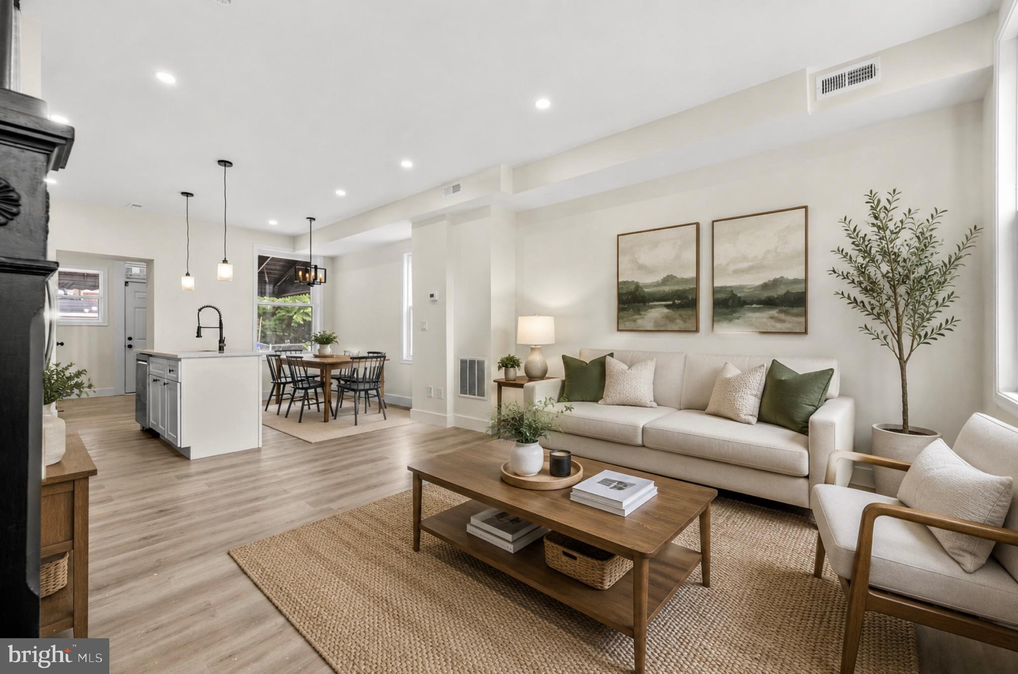 Welcome home to this beautifully renovated end-unit townhome located in the desirable Waverly neighborhood of Baltimore City. This move-in-ready home features 2 spacious bedrooms, 1 full bath, 1 half bath, and a fully finished basement offering versatile living space.

The main level showcases an open-concept floor plan with hardwood flooring, large windows that fill the home with natural light, and a stylish kitchen complete with stainless steel appliances, a center island, and a separate dining area. A convenient powder room is also located on the main level.

Upstairs offers a spacious primary bedroom, a generously sized second bedroom, and a beautifully updated full bathroom with modern finishes.

The fully finished lower level offers exceptional additional living space, featuring a spacious recreation area perfect for entertaining, relaxing, or creating a media room. A separate finished bonus room provides flexibility for a home office, guest room, gym, or hobby space. The lower level also includes a dedicated utility and laundry room with washer and dryer, providing added convenience and storage.

Enjoy the convenience of both street parking and a private rear parking pad. Ideally located in the heart of Waverly, this beautifully updated home is close to shopping, dining, and parks, offering the perfect combination of modern finishes, functionality, and city convenience.