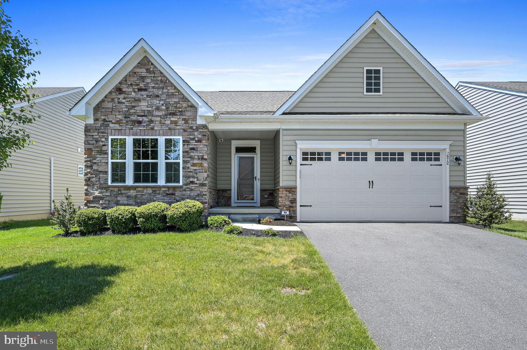 Welcome to 672 Southerness Drive, a beautifully appointed ranch-style home in the highly desirable 55+ community of Legacy at Odessa National. Built in 2019, this spacious 2-bedroom, 3-bath home offers an impressive 2,484 square feet of finished living space with a thoughtfully designed main-level layout and a finished lower level.

Step inside to an inviting open floor plan filled with natural light, hardwood flooring, and elegant finishes throughout. The heart of the home is the expansive kitchen, featuring white cabinetry, quartz countertops, stainless steel appliances, a large center island, and a bright breakfast/morning room that flows seamlessly into the family room. The main living area is anchored by a beautiful gas fireplace, creating the perfect setting for everyday living or entertaining.

The private primary suite is tucked toward the rear of the home and offers a comfortable retreat with a spacious bedroom and well-appointed bath. An additional main-level bedroom provides space for guests, with the added bonus of a home office. A covered rear porch extends the living space outdoors, offering a quiet place to relax and enjoy the neighborhood setting.

The finished basement adds exceptional value with a large recreation area, bar, second living space, full bathroom, and additional storage—ideal for entertaining, game nights, hobbies, or hosting overnight guests. The home also includes an attached 2-car garage and low-maintenance living with HOA services that include lawn maintenance and snow removal.

Located in Legacy at Odessa National, residents enjoy access to community amenities including a clubhouse, fitness center, outdoor pool, golf course, walking/jogging paths, and tennis courts. This is a rare opportunity to enjoy comfort, space, and convenience in one of Townsend’s most sought-after active adult communities.