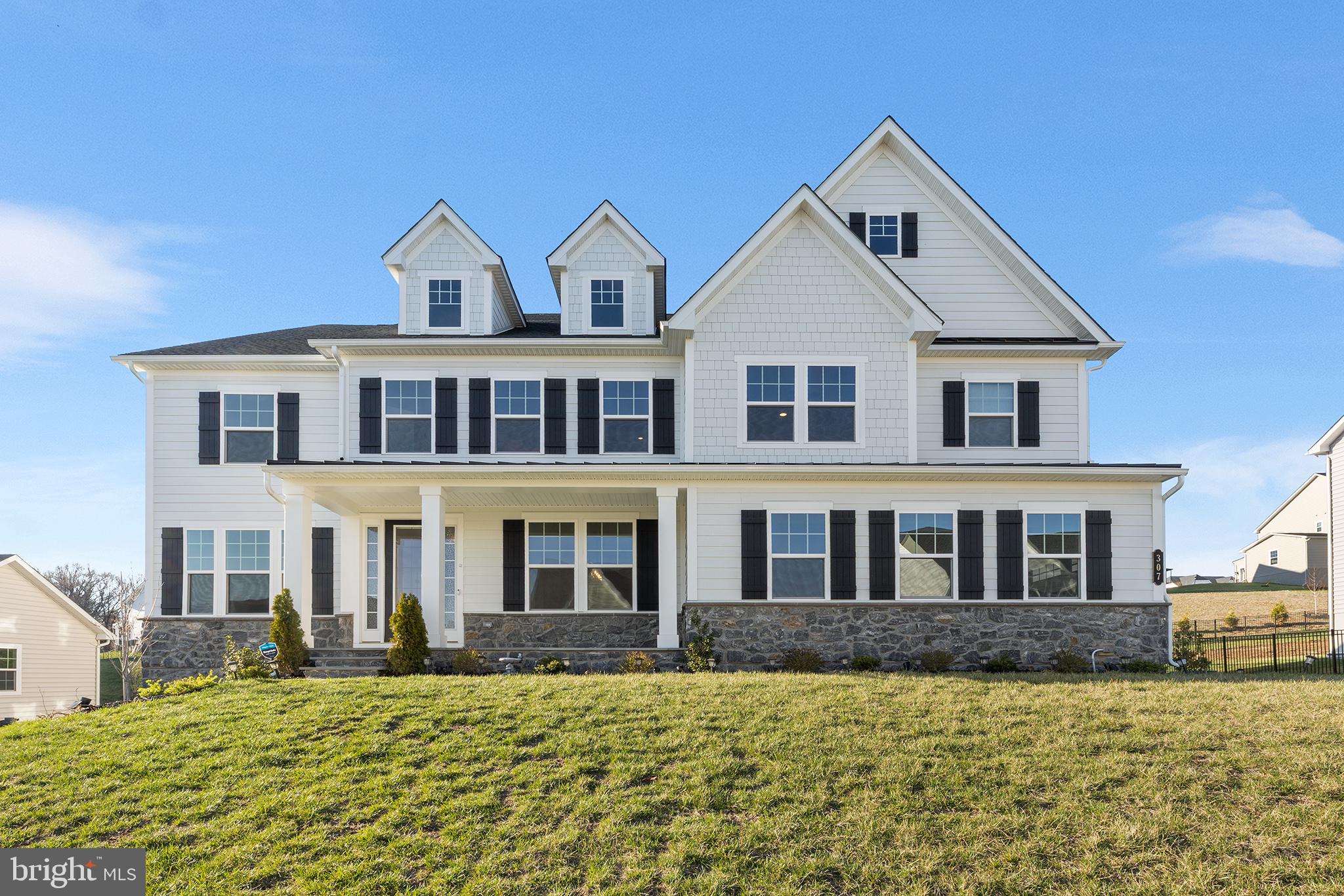 Move-in ready Stratford Hall model in sought-after Greystone is available for immediate occupancy! This spectacular one-year young home in West Chester school district, includes 4,400 sf of luxury living space plus an additional 2,000 sf of meticulously finished space in the walk-up basement.  The curb appeal starts with the extended front elevation complimented by a striking James Hardie and stone façade that's further accentuated by the inviting covered front porch with slate flooring. Inside, you’ll instantly be drawn to the light-filled foyer and eye-catching 6” hardwood, which has been upgraded throughout the main and upper levels. The foyer is flanked by a private office with glass panel French doors and an inviting flex space, ideal for a formal living or dining room. Across from the staircase is the first of 6 ensuites, a great option for generational family members or guests. Continue into the impressive two-story family room with a dramatic floor-to-ceiling Palladian-style window that's trimmed in striking millwork. From the family room, the open concept design flows into the state-of-the art gourmet kitchen with premium level white cabinetry, energy-efficient appliances, top-of-the-line quartz countertops, coordinating backsplash and a spacious walk-in pantry. There is an extended island with more than ample seating for four, a dining area for more informal meals and an impressive butler’s pantry with glass-front upper cabinets and quartz countertops. Adjoining the kitchen is the family entry with garage access and a roomy drop zone featuring built-in cubbies. Continue upstairs, where you’ll instantly be drawn to the luxurious primary suite. A private sanctuary with spa-like amenities such as walk-in shower with bench seat, dual vanities, quartz countertops, soaking tub, stylish tile, tray ceiling, custom designed California closets and more. The upper level also includes three additional generously sized junior suites, all with luxury finishes, an expanded loft upgrade and a conveniently located laundry room with built-in utility sink vanity. As an added bonus, the fully finished walk-up basement is thoughtfully designed with an expansive recreation room,  theater room with fully wired home theater system, and 6th bedroom suite. Suffice to say, this executive-style  home is turn-key with virtually every builder upgrade and then some. Additional highlights include but are not limited to upgraded electrical package with smart wiring and e-car charger, smart Ecobee climate control system with humidifier, remote controlled blinds, California closets, ceiling fans, black matte trim, and more.  Conveniently located close to shops, West Chester Borough, restaurants, Philadelphia and major highways. Showings commence with the open house on April 6th. (Note: taxes were successfully appealed and lowered!)