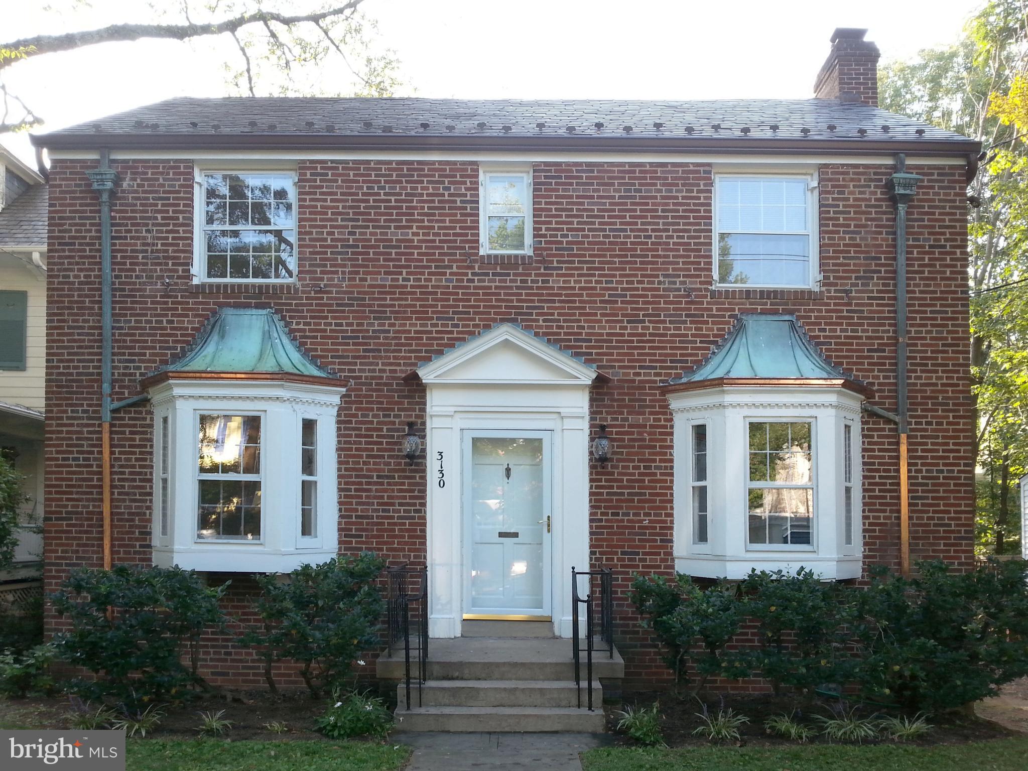 Welcome to 3130 38th St NW, a charming 3 bedroom, 2.5 bathroom traditional Colonial home in the historic and highly desirable Cleveland Park neighborhood of Washington, DC. The living room is bright and inviting, complete with a wood burning fireplace. The dining room has lots of sunlight and is big enough for a full-sized dining table. The kitchen features plenty of cabinet space, quartz counters and a porcelain tile floor. From the kitchen, a staircase leads out to a large flagstone patio overlooking a generous backyard. The living and dining rooms have hardwood floors and beautiful bay windows that look out onto the street. Off the living room is a spacious screened porch, large enough to include a dining table and chairs, to entertain during the warmer weather. The first floor also has a half bath.
The upper level of the house has hardwood floors as well and features three spacious bedrooms and two bathrooms. The primary bath is ensuite. The below ground level has a half bathroom, and a finished space usable as an office or playroom. The laundry, also in the basement, has a new washer and dryer. The home's extra deep backyard is an entertainer's dream, offering ample space for outdoor activities, gardening, and play. The property has a one-car garage and a driveway with plenty of room to park several cars. 
Located in the highly sought-after Cleveland Park neighborhood, the home is a block and a half to the Giant and CVS, and two blocks from restaurants, bars and coffee shops along Wisconsin Avenue. The National Cathedral and its landscaped grounds are a block away. The neighborhood is approximately two miles from downtown DC, so it is an easy commute to downtown. The house is currently tenanted.