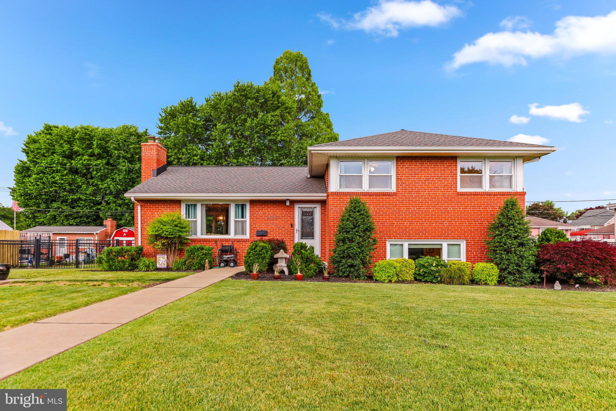 Welcome to 2902 Richie Ave in Edgemere, a beautifully updated 4-bedroom, 2-bath split-level home that combines modern finishes with the comfort and charm of this classic Baltimore County neighborhood. Step inside to a spacious layout featuring gleaming hardwood floors throughout. The main level offers an open-concept design with combined living, dining, and kitchen spaces centered around a cozy fireplace, creating an inviting atmosphere for everyday living and entertaining alike. The updated kitchen features rich espresso cabinetry, contrasting light granite countertops, stainless steel appliances, and an expanded breakfast bar for additional seating and functionality.  The upper level includes three generously sized bedrooms and an updated full bathroom. The first lower level offers a flexible layout with a fourth bedroom currently used as a large family room, along with an additional den or recreation space. The lowest level provides abundant storage and a brand-new full bathroom. Outside, the oversized detached garage is a dream space for hobbyists, mechanics, or anyone in need of extra workspace, complete with electric, heating, and cooling.  This home is truly move-in ready, with many major updates already completed, including a newer roof, zoned heating and air conditioning, and replacement windows. The Edgemere area, known for its waterfront history and Chesapeake Bay access, blends historic character with local parks, marinas, and outdoor recreation. Residents enjoy close proximity to Sparrows Point Park, North Point State Park, and several waterfront areas within approximately 2 miles of the property, offering walking trails, fishing piers, playgrounds, sports fields, and scenic water views. Convenient access to shopping, dining, commuter routes, and downtown Baltimore makes this location an excellent combination of comfort and convenience.