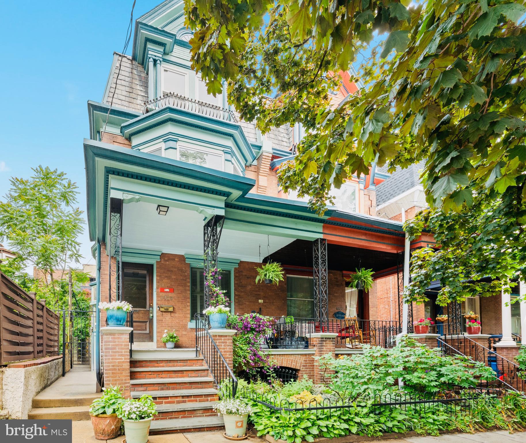 Welcome to 4429 Larchwood Avenue! This beautiful 5 bedroom, 2.5 bath Victorian porch-front twin with excellent outdoor space has all of the historic character and charm, modern upgrades, extra space and light you've been looking for! As you pass the lush front garden and spacious porch, you'll be greeted by a bespoke vestibule featuring custom hand-painted wallpaper. Once you cross the threshold, you know you're in one of Spruce Hill's loveliest homes.

The living room features two decorative fireplaces, built-in bookshelves, stained glass windows, bay window seating, and a handy coat closet to help keep things tidy. The original hardwood floors flow into a spacious dining room perfect for hosting friends and family. A swing door welcomes you to an expansive eat-in kitchen with a warm terracotta tile floor, a grand oven that is vented to the outside, dishwasher, generous counter space and storage, and an original floor-to-ceiling wooden cupboard. The kitchen extends into a convenient laundry area with a good-sized powder room, and an additional pantry and bonus prep space so you can easily whisk your goodies outside to the tranquil backyard space, perfect for summer barbecues and low maintenance gardening.

Head back inside to make your way upstairs and enjoy a built-in M.C. Escheresque woodwork piece on the way up, just one of the many charming details that abounds throughout this home. On the 2nd level you'll find three bedrooms and an updated bathroom with a stall shower. The 3rd floor boasts two more bedrooms, plus another full bathroom with a clawfoot soaking tub. A custom made walk-in closet completes this level.

Bonus storage space awaits in the upstairs attic, along with future potential to convert to more livable space if ever needed. The full and deep basement is 70% finished with closets galore and excellent ceiling height. Additional home highlights include air conditioning, ceiling fans, updated windows and coverings, porch swing, and established plantings in both front and back gardens.
This West Philly winner sits on a tree lined block that is on the beloved Spruce Hill Halloween Parade route, and this block recently celebrated its 40th annual block party which this family home steward helped get started! Close to universities, Baltimore Avenue's amenities, public transportation, multiple playgrounds, hospitals, grocers, University Swim Club, Mariposa CoOp, Cobbs Creek Nature Center, and Clark Park with its year-round farmer’s market.

You'll love being in an area that has significant architectural and historical significance, exciting development activity, and great walkability. Plus you’ll enjoy an easy commute to Center City by car or bike, with plenty of convenient bus, trolley, and regional rail options. All in the award-winning Penn Alexander School catchment. Welcome home!