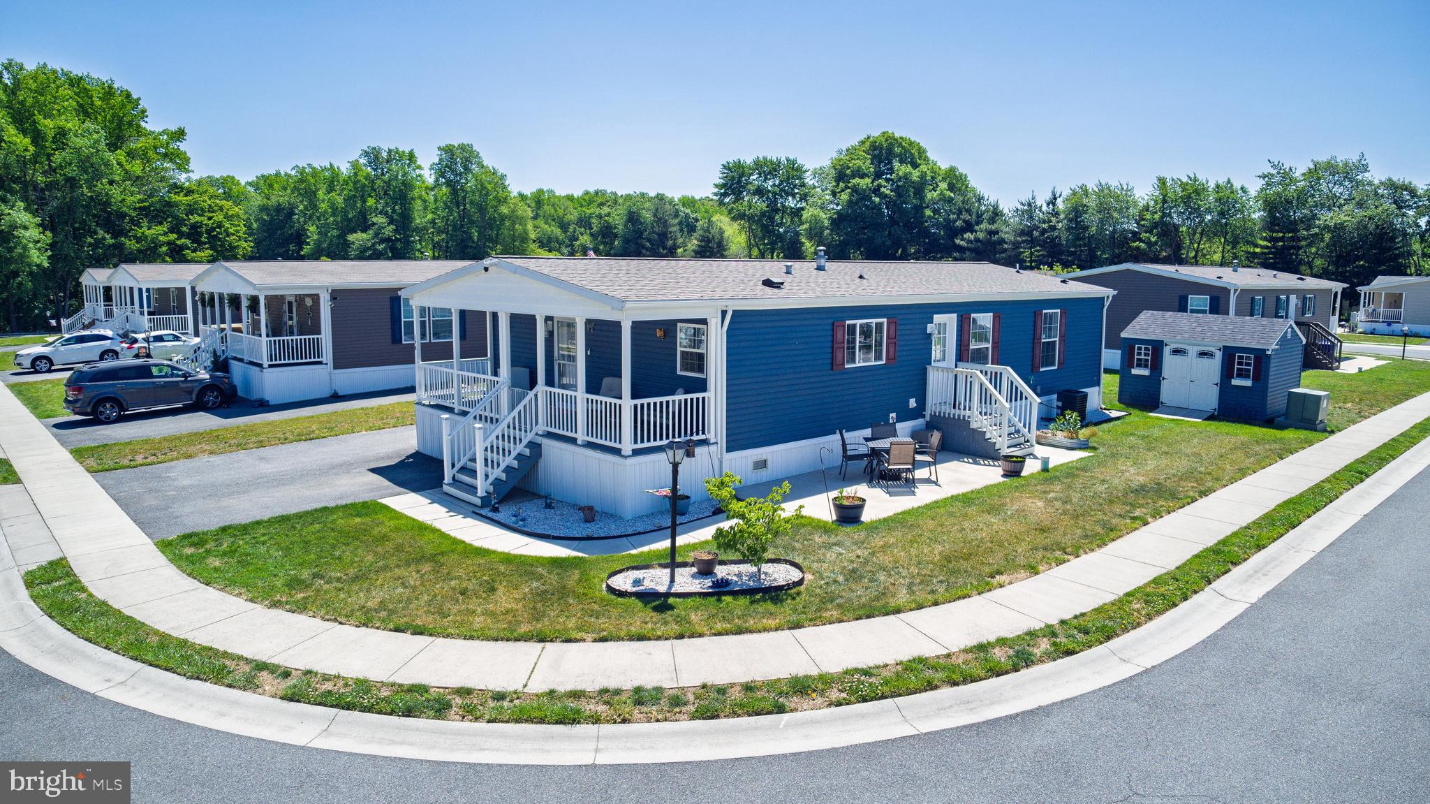 Welcome to Ridgewood Point, Smyrna, Delaware’s premier 55+ active adult community! Built in 2023, this beautifully designed home offers a bright, open-concept floor plan enhanced by gorgeous luxury vinyl plank flooring throughout the main living areas. The ample kitchen features a large center island, stainless steel appliances, abundant cabinetry, and plenty of space for cooking and gathering. This lovely home includes three comfortable bedrooms and two full baths, highlighted by a generous primary bedroom with a walk-in closet and private en suite bath complete with a walk-in shower. Start your mornings with coffee on the breezy covered front porch, or spend sunny afternoons relaxing or entertaining on the patio. This home comes complete with all appliances and a 10 x 14 custom shed included. Ideally situated just outside town limits, this charming home combines low-maintenance living with low property taxes and energy efficient affordability. Enjoy the privacy of this peaceful enclave yet conveniently close to shopping, restaurants, healthcare, Route 13 & Route 1 for easy access to points north and south.  Land Lease $739.21 includes sewer service .  Schedule your tour today!