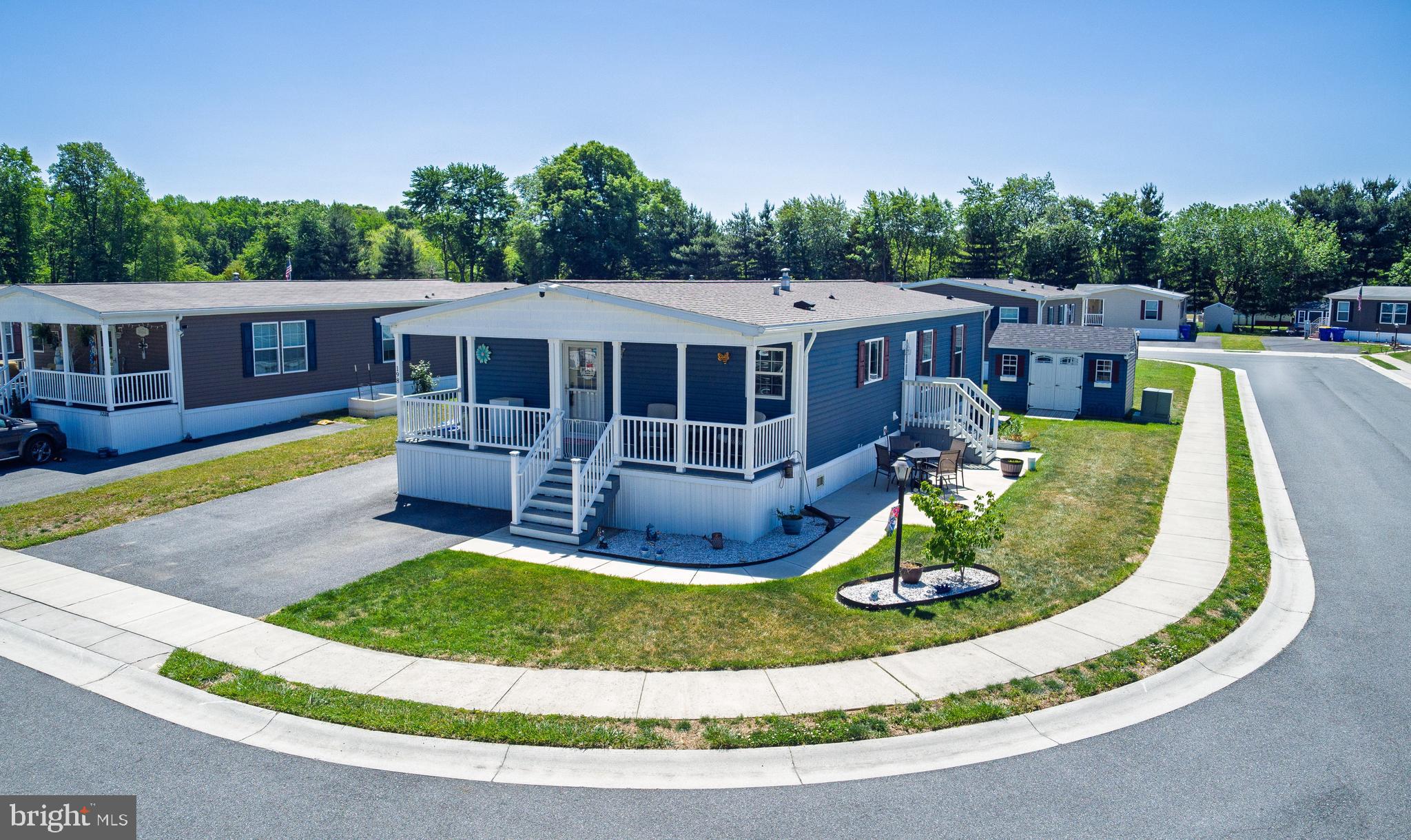 Welcome to Ridgewood Point, Smyrna, Delaware’s premier 55+ active adult community! Built in 2023, this beautifully designed home offers a bright, open-concept floor plan enhanced by gorgeous luxury vinyl plank flooring throughout the main living areas. The ample kitchen features a large center island, stainless steel appliances, abundant cabinetry, and plenty of space for cooking and gathering. This lovely home includes three comfortable bedrooms and two full baths, highlighted by a generous primary bedroom with a walk-in closet and private en suite bath complete with a walk-in shower. Start your mornings with coffee on the breezy covered front porch, or spend sunny afternoons relaxing or entertaining on the patio. This home comes complete with all appliances and a 10 x 14 custom shed included. Ideally situated just outside town limits, this charming home combines low-maintenance living with low property taxes and energy efficient affordability. Enjoy the privacy of this peaceful enclave yet conveniently close to shopping, restaurants, healthcare, Route 13 & Route 1 for easy access to points north and south.  Land Lease $739.21 and includes trash removal.  Schedule your tour today!