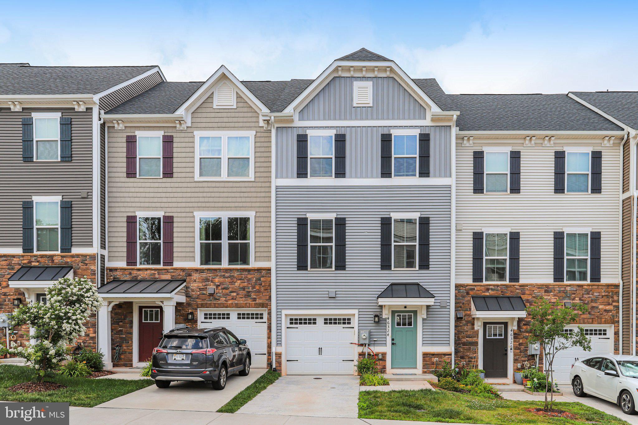 Welcome to 46324 Mount Kellogg Terrace, a stunning, like-new townhome built in 2023 by Ryan Homes in the highly desirable Loudoun Overlook community of Sterling, Virginia. Offering 2,340 square feet of beautifully finished living space, this contemporary home features 4 bedrooms, 3 full bathrooms, and 1 half bathroom, thoughtfully designed for today's lifestyle.

The main level showcases a bright, open-concept floor plan that seamlessly connects the living room, dining area, and gourmet kitchen—perfect for everyday living and entertaining. The kitchen is the heart of the home, featuring an oversized center island, elegant quartz countertops, abundant cabinetry, and modern finishes.

The entry level offers a spacious family room with soaring ceilings, a convenient half bath, hallway storage, and direct access to the attached one-car garage. A private driveway provides an additional parking space for a total of two dedicated parking spots.

Upstairs, the luxurious primary suite serves as a peaceful retreat with a generous walk-in closet and a beautifully appointed en-suite bathroom. Two additional bedrooms, a full hallway bath, and a conveniently located laundry area complete this level.

The upper level provides exceptional flexibility with a fourth bedroom that can also serve as a private home office, guest suite, or additional family room. This level includes its own full bathroom and opens to a private balcony, creating the perfect space to relax or work from home.

One of this home's standout features is its three private balconies, offering multiple outdoor living spaces to enjoy fresh air and spectacular views. From the rear of the home, you'll overlook the community pool while enjoying distant views of the Blue Ridge Mountains and breathtaking sunsets.

Residents of Loudoun Overlook enjoy outstanding community amenities, including a resort-style outdoor swimming pool, basketball courts, pickleball courts, playgrounds, walking trails, and beautifully maintained common areas. Conveniently located near major commuter routes, shopping, dining, Dulles International Airport, and the Silver Line Metro, this exceptional home combines modern luxury, convenience, and an unbeatable location.

Don't miss the opportunity to own this move-in-ready home that perfectly blends style, comfort, and scenic views in one of Loudoun County's most sought-after communities.