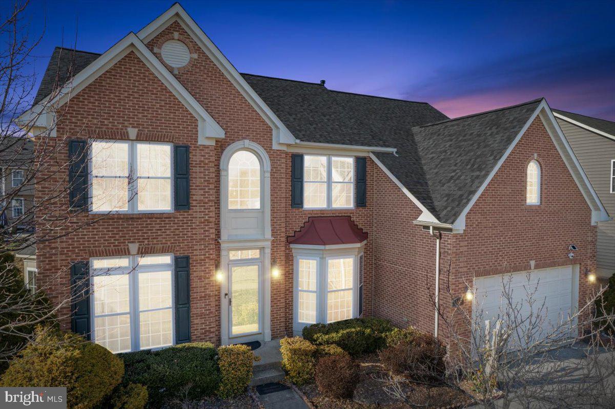 Welcome to this stunning three-level brick-front Colonial located in the highly sought-after Charles Crossing community. Offering over 5,700 square feet of finished living space, this beautifully maintained home delivers the perfect blend of elegance, comfort, and functionality.  The main level showcases 9-foot ceilings, crown molding, chair rail, shadow boxing, decorative columns, recessed lighting throughout, and gleaming hardwood floors. A dramatic two-story open foyer welcomes you inside. Formal living and dining rooms provide ideal spaces for entertaining. The spacious family room features a cozy gas fireplace, ceiling fan with light, and recessed lighting, creating the perfect setting for relaxing evenings. Two columns separate the family room from the light-filled sunroom, which offers floor-to-ceiling windows, a vaulted ceiling, chair rail, shadow boxing, and abundant natural light, adding additional versatile living space.  The gourmet kitchen is truly a chef’s delight, featuring sleek stainless steel appliances, abundant counter space, tile backsplash, recessed lighting over the bar area, pendant drop-down lighting, a large center island with eat-in bar seating, and a generous walk-in pantry. Designed for both everyday living and entertaining, this kitchen offers the perfect combination of style and function. A convenient half bath completes the main level. Step outside to the rear patio—perfect for cookouts and outdoor gatherings. The home also features a two-car front-load garage.  Upstairs, retreat to four spacious bedrooms, including a luxurious primary suite designed for relaxation, complete with a vaulted ceiling in the primary bedroom, recessed lighting, ceiling fan with light, crown molding, chair rail, shadow boxing, and a sitting area also featuring a vaulted ceiling and separated by two decorative columns. The spa-inspired primary bath offers tile flooring, two separate vanities, a step-down soaking tub with tile surround, a separate tiled shower with bench seating, ample counter space, and a private water closet, creating a true retreat experience. An additional full bath and a conveniently located upper-level laundry room provide everyday convenience.  The fully finished lower level significantly expands the living space and includes a private guest or in-law suite with a second kitchen, two additional bedrooms (NTC), a full bath, a large recreation room, workout area, and flexible space to meet your needs. New Roof 2025 Architectural shingles. Residents of Charles Crossing enjoy community amenities including a pool, playground/tot lot, and tennis courts.
Don’t miss this exceptional opportunity to own a beautifully appointed home in a desirable community.