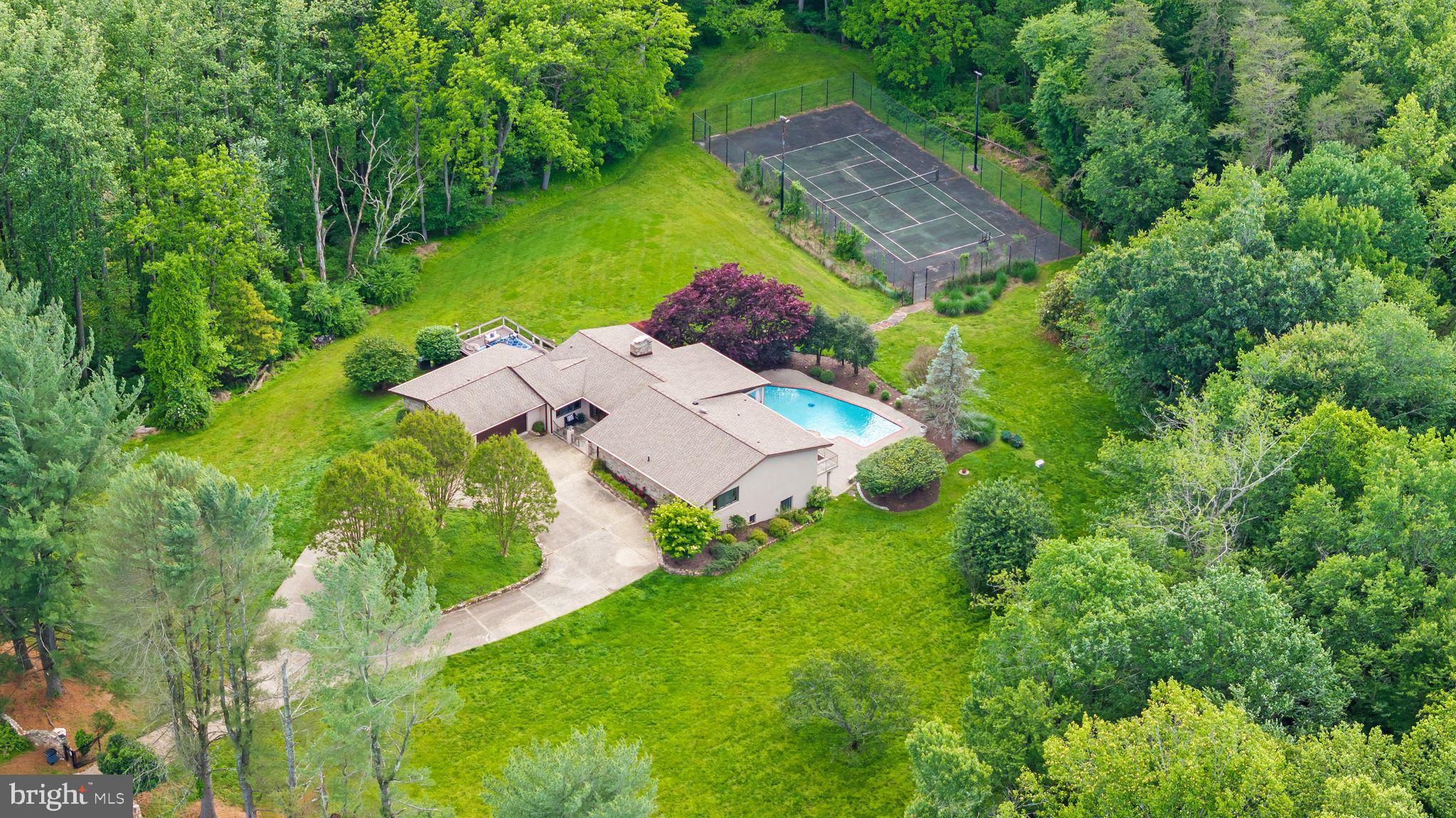 Welcome to your own private oasis in highly sought-after Monkton. Tucked away at the end of a quiet cul-de-sac on more than five breathtaking acres, this exceptional property offers a rare combination of privacy, natural beauty, and convenience. Surrounded by mature trees and accessed by a stunning, tree-lined gated driveway, you'll feel a world away while still having easy access to Towson, Hunt Valley, Baltimore City, and beyond.

Expansive views of open landscape and towering trees create a truly tranquil setting. The outdoor living experience is second to none, featuring an oversized sparkling blue pool that has been recently resurfaced and enhanced with new equipment and a new cover. Multiple patio and entertaining spaces invite you to relax, dine al fresco, and enjoy the peaceful sights and sounds of nature—you may never want to eat a meal indoors again.

Inside, the home has been thoughtfully updated and meticulously maintained. The kitchen features recently replaced appliances, while major improvements include everything from a new roof in 2020 to a new water heater in 2026.

The walkout lower level is an entertainer's dream, complete with a full bar, wine room, game room, home office, additional bedroom, and full bath, all with direct access to the pool area. Outside, enjoy the charm of collecting fresh eggs from your own chickens, and imagine the possibilities for the existing tennis courts, ready to be restored to their former glory.

With a two-car garage, spectacular grounds, abundant wildlife, and unmatched privacy, this is more than a home—it's a lifestyle. Welcome to your own private Monkton retreat.