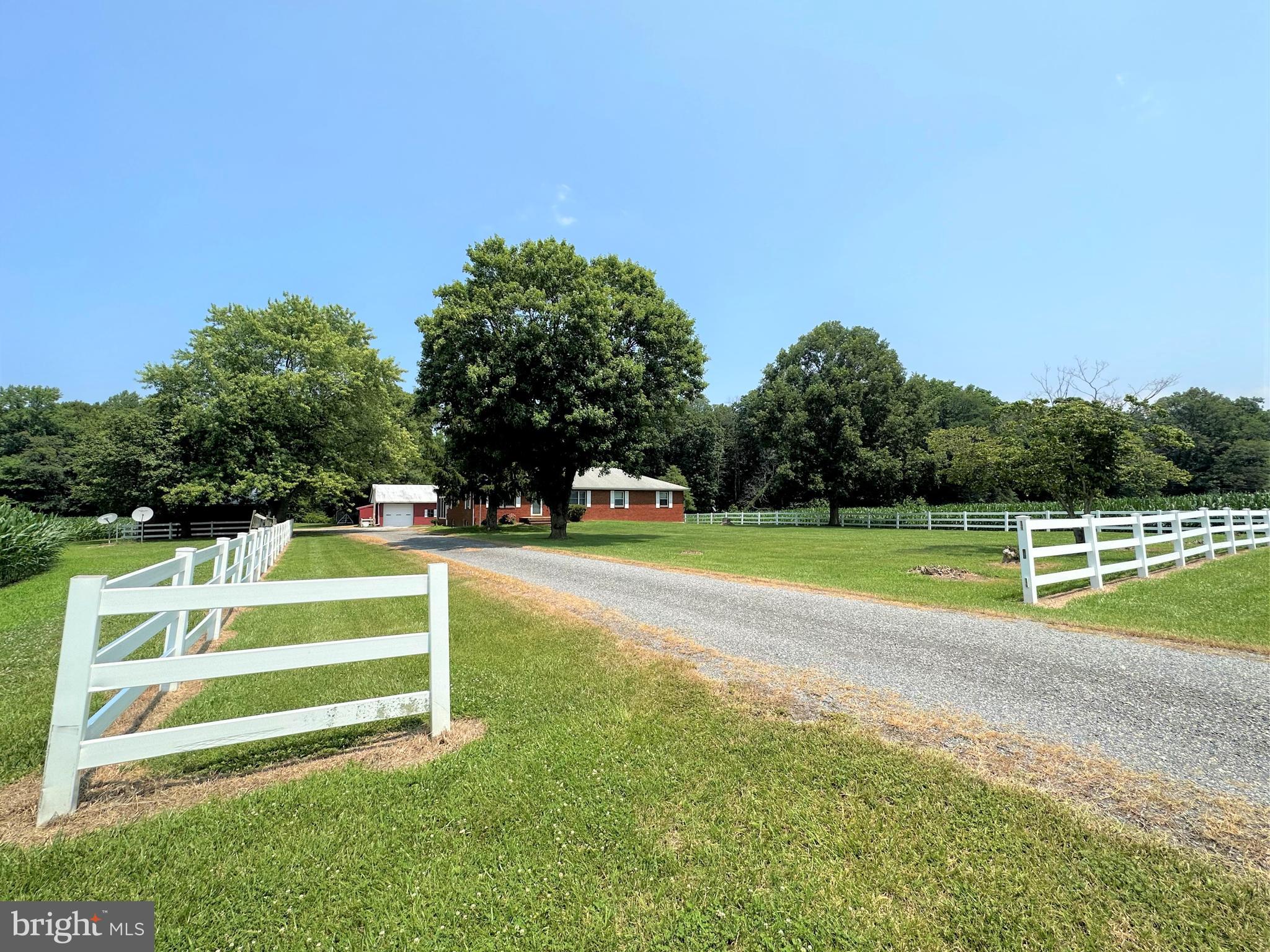 VERY MOTIVATED SELLER HAS REDUCED THE PRICE AGAIN!!   Look again at this RARE and UNIQUE property in Queen Anne’s County.  Very well maintained, spacious, move-in-ready brick rancher with basement sited on 43+ acres....2000+ sqft custom-built home features large bedrooms (primary bedroom with 2 closets &  updated bathroom), 3 full baths, kitchen with lots of cabinetry, separate dining room, living room overlooking farmland and mudroom/laundry with over-sized utility sink...Massive basement approx 1800 sqft, partially finished with woodstove and full bath.  Highlights of the home include slate foyer, a personal walk-in jacuzzi tub/shower, central vacuum and intercom system.  You can enjoy the view relaxing, or entertaining guests in the large, enclosed porch.  The home is bordered with a vinyl fence with an additional 3-car carport and a large 46x76 barn.  The barn features a large workshop, equipment storage area, 4 stalls and a tack room.  11+ beautiful acres of tillable land and 30+ acres woods loaded with White-tail deer, turkey, and other wildlife.  Convenient access to Middletown, Easton, Dover, and Bay Bridge.  Stop by to experience the view and serenity of this beloved homestead..