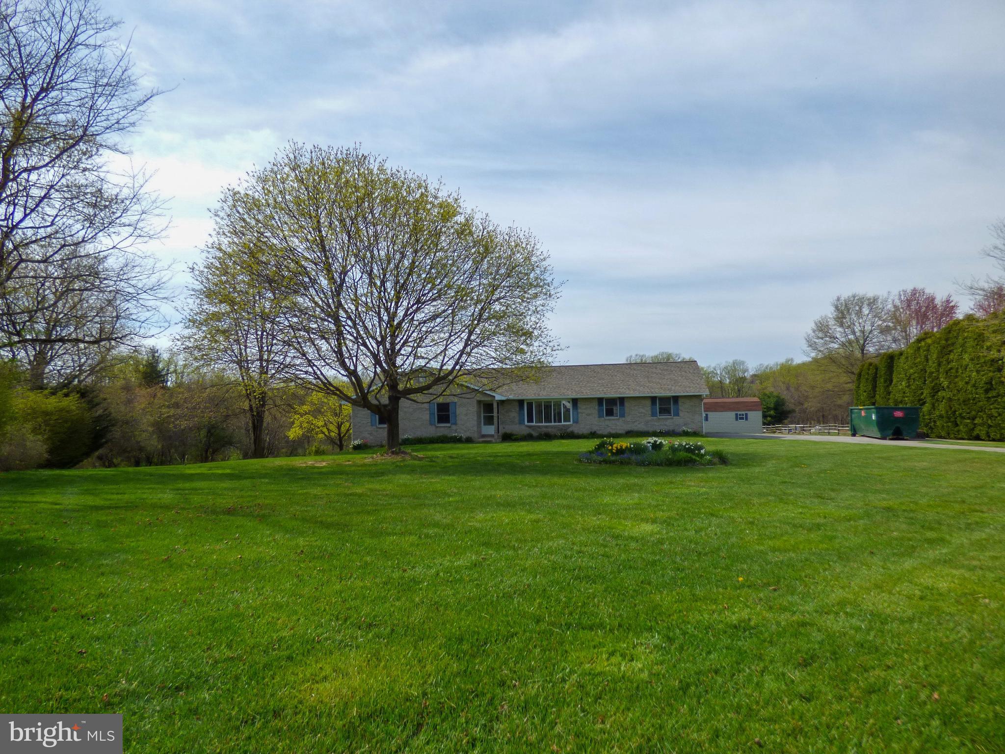 Here’s the solid brick rancher in beautiful South Eastern Schools you’ve been looking for!  1.488 acre corner lot with views of farmland has plenty of room for your family, a family garden, a pool and a 12 x 20 shed.  This property has it all! This home is close to Kennard-Dale High School, and a short drive to the Maryland line!  WOW!  Only a 5 year old roof, a 3 year old furnace, a 6 year old water heater and a 3 year old central air conditioning system!  Check out all the storage of this home’s basement and even more storage in the end load 2 car garage with 2 garage doors on automatic openers.  This home has a security system, hard wired speakers, a walk out basement with double doors on the gable end newer neutral pile carpeting and all the appliances are included except the freezer in the basement.  This home has a 300 ft deep well which has never run dry, a 1,000 gallon septic tank which was pumped in 2020 and all the nature you’d hope to see in a location like this:  deer, fox and wild turkeys have crossed this property at various times of the year.  This home has a 1st floor laundry, great sized bedrooms and very few steps.  For your safety please do not open the door in the eat in kitchen or the master bedroom as the deck has been removed.  Hurry - a  sold brick rancher on a corner lot of this size will NOT last long!
