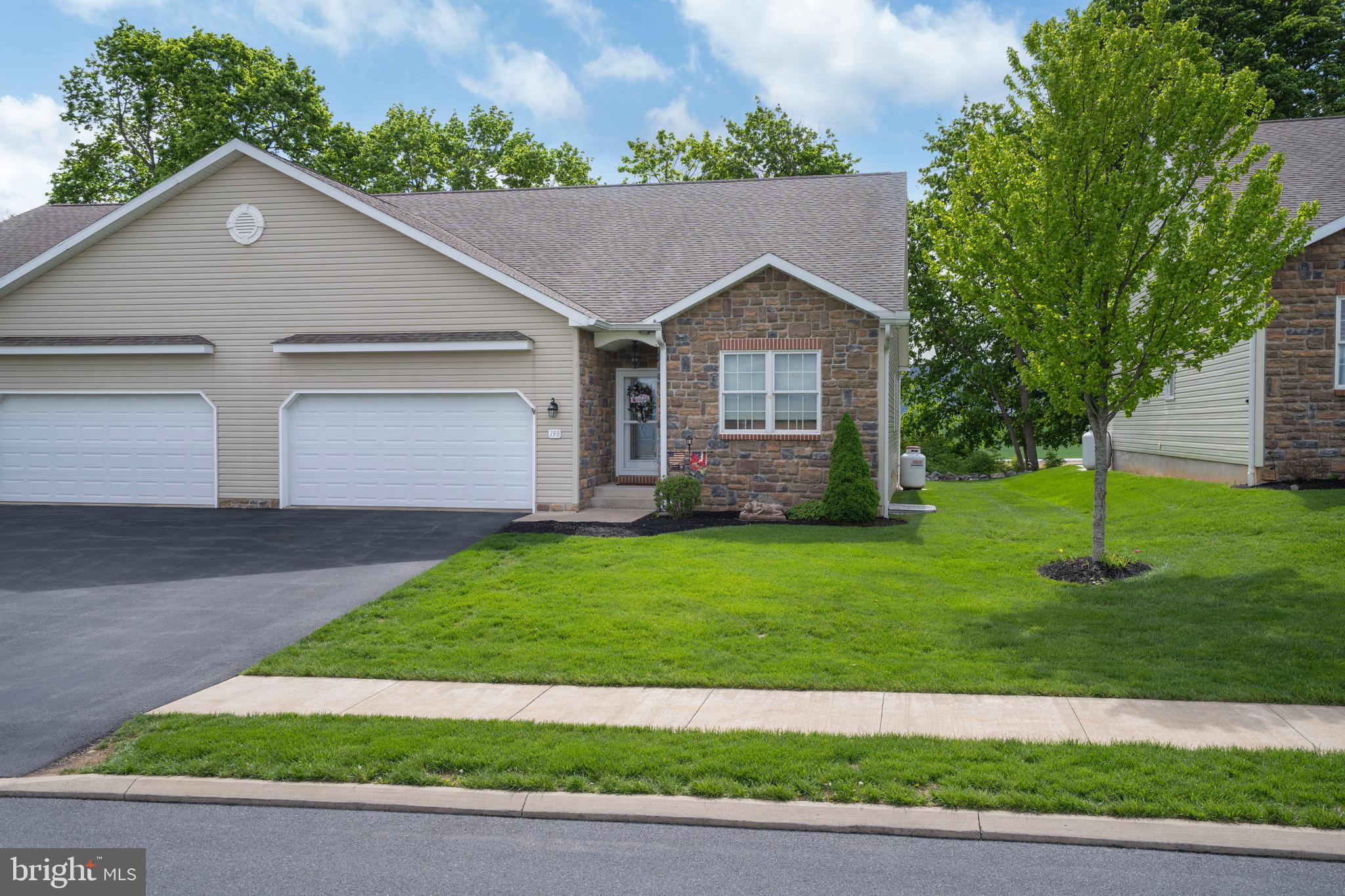 Experience the Best of Rosewood Cove Living in This Beautifully Custom Finished Condo. Enjoy the ease of seamless single level living with a finished lower level, tucked away in the tranquil Rosewood Cove community on the outskirts of historic downtown Bellefonte. Located just off Blanchard Street & less than 2 miles from I 99, this prime location offers a quick commute to State College & Penn State University while still providing a peaceful, tree lined setting.  Immaculate, one owner & truly move in ready, this unit features an open concept design crafted to impress. The grand great room showcases a soaring vaulted ceiling & cozy propane fireplace, creating a warm & inviting focal point. The dining room highlights gleaming Hickory hardwood flooring &  sliding glass doors that lead to the rear Trex deck & expanded patio, offering the perfect vantage point for endless farm views and neighboring mountain ranges. The dining area flows effortlessly into the beautifully appointed kitchen, where rich Hickory hardwood flooring continues to add warmth & elegance. You’ll love the abundance of crisp white cabinetry, paired with a stylish ceramic tile backsplash & generous countertop space ideal for everything from weeknight dinners to weekend entertaining. A spacious breakfast bar with elegant pendant lighting offers the perfect spot for morning coffee, casual meals or gathering with guests. The kitchen comes fully equipped with included appliances & also features a handy pantry for extra storage.  Just beyond the kitchen offers direct access to the attached 2 car garage, making daily routines feel effortless.  The relaxing primary suite features a large walk in closet & an attached private full bath with ceramic tile flooring, a walk in shower & soaking tub. An additional bedroom with its own walk-in closet, another full bathroom & a dedicated laundry room with included washer & dryer completes the main living area.  The finished walk out lower level expands your living options with a spacious family room ideal for game day gatherings, a home office, another bedroom & a full bath providing flexible space for guests or multi purpose living.  Unfinished space offers ample storage.  A low monthly condo fee covers exterior building maintenance, exterior insurance, lawn care, snow removal & trash, making this home an ideal choice for those with a busy lifestyle or anyone seeking low maintenance living in a serene setting.  Thoughtfully designed, beautifully appointed & intended for effortless living, this Rosewood Cove gem delivers comfort, convenience & a peaceful sense of home from the moment you arrive.