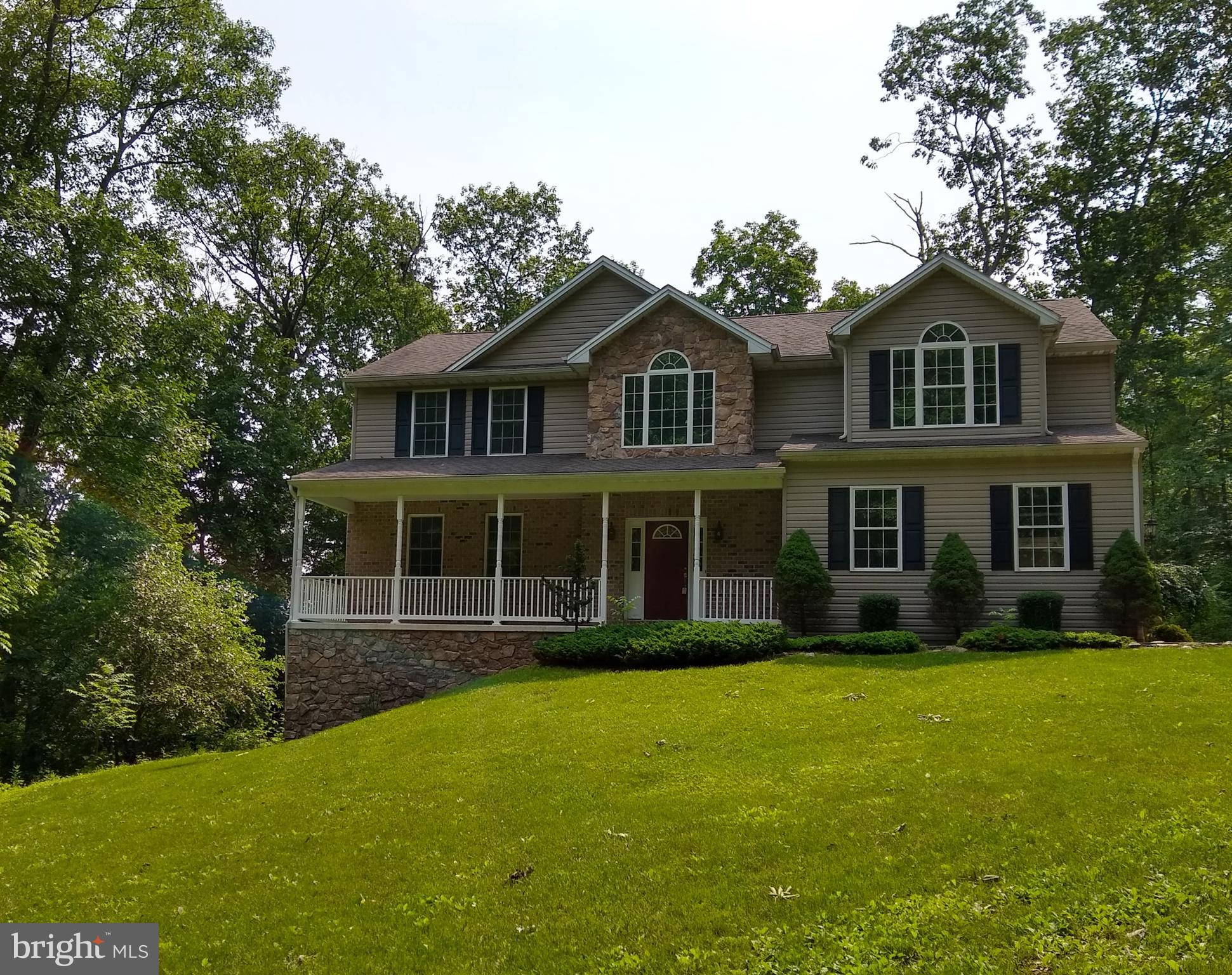 Now priced far below value and new construction pricing! No waiting for a build while hoping to be in before the end of the year. Come see this custom home in a private location, yet with quick access to I-83. This home has hardwood floors on the first level, 9' ceilings, stone surrounded fireplace with bookcases built in, a dining room that captures the outside through the bay window,  a large kitchen with granite and  42" kitchen cabinets for ample storage, a large laundry room all on the first floor. Upstairs can be found the private quarters with super sized owner's suite, 3 additional bedrooms and a split bath hall bath which allows for 2 person usage.  The open foyer is lit by a palladian window with hall and stair carpeting  replaced in 2018. The basement is awaiting your plans! It has been studded out and insulated, and has a double wide access door if you need to bring in large items to the workroom, or for the storage of outdoor furnishings.  Add central vac, stamped concrete walk-ways, newer deck with composite decking and rails and this home situated on 1.5 private acres is a need to see.