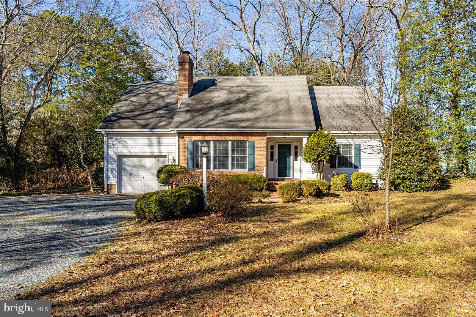 MAJOR PRICE REDUCTION! SUBSTANTIALLY BELOW JAN 2026 APPRAISED VALUE! ALSO... NEW 30-YEAR GAF ARCHITECTURAL ROOF SHINGLES TO BE INSTALLED PRIOR TO SETTLEMENT! Nestled on a wooded lot near Covered Bridge, this charming 2340 SF, 4 bedroom, 3 full bath cape cod offers inviting spaces to entertain guests as well as enjoy day to day living.  The welcoming entrance hall features a vaulted ceiling and hardwood staircase. The spacious living room is enhanced by a masonry fireplace w/ gas log insert and log storage box and is open to the eat-in kitchen that includes a small portable prep island, built-in corner cabinet, solar tube for natural light, and direct access to a cozy sunroom that brings the outdoors in courtesy of 2 delightful walls of windows and an atrium door. The 1st floor also includes 2 bedrooms; each w/ walk-in closets, and 2 full baths. The 2nd floor offers 2 spacious bedrooms (one w/ direct access to the hall bathroom) and a walk-in attic. Other features of the home include a one-car garage w/ electric opener, in-ground irrigation w/ private well, sidewalks from the driveway to the front door and rear sunroom door, natural gas heat on the 1st floor, HP on the 2nd floor, and a tankless gas water heater. HVAC serviced bi-annually by Mid Atlantic Heating and Air.