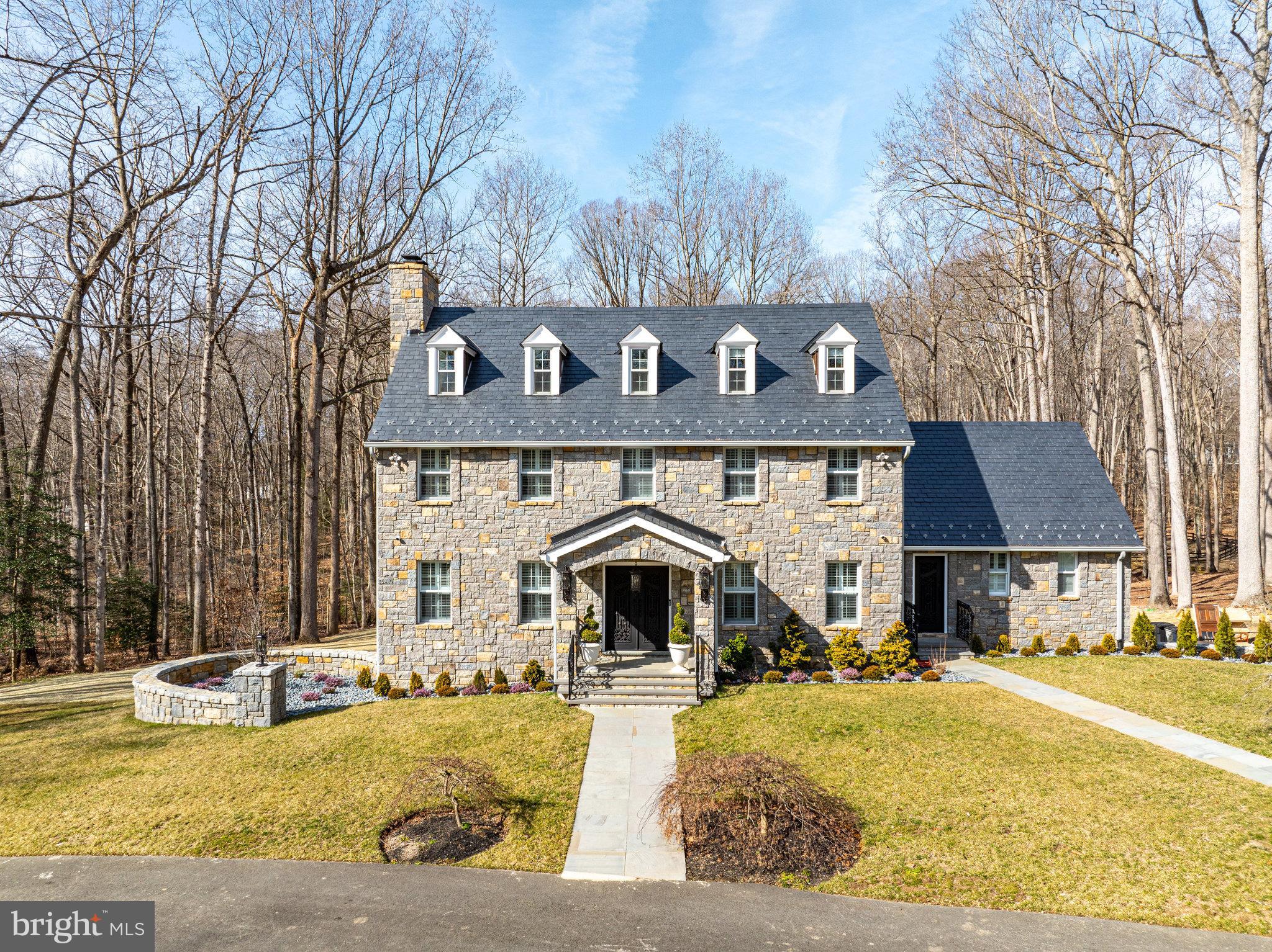 Perfectly situated on a quiet cul-de-sac near the historic and charming village of Clifton and sited on 5 gorgeous acres, this one-of-a-kind home offers 5 bedrooms, 3 1/2 baths and beautiful details in every room.  Meticulously remodeled and expanded with no expense spared, this home boasts impressive design elements, perfect for entertaining and impressing guests, such as a completely remodeled kitchen, remodeled bathroom with imported stone – just to name a few.  The exterior offers Ashlar stone installed on the entire exterior face of the house, professional landscaping, an expansive lawn and barn with 6 stalls and large paddock. Convenient  bridle path encircles the entire neighborhood making this home the perfect equestrian retreat. Downtown Clifton is just minutes away and only 7 miles to the Burke Centre/VRE train station. 

The stunning renovated gourmet kitchen includes 2 huge waterfall islands with unique blue granite.  Well appointed “Chefs” kitchen with all Thermador appliances including: 6 burner induction cooktop, 2 dishwashers, and full size Fridge and Freezer.  Impressive coffered ceiling flows from the kitchen into the large family room with impressive ”Fusion Wow Granite”  fireplace. Retreat upstairs to the Owner’s Suite with fireplace, spa-like bathroom and 2 walk-in closets.  The upper level offers 2 more bedrooms, a full bath and a 3rd floor with 2 additional bedrooms and a full bath.  All secondary bedrooms offer hardwood floors with exquisite bathrooms. The walk out lower-level features Rec room space and large unfinished storage space. The oversized garage features commercial grade chip proof flooring.