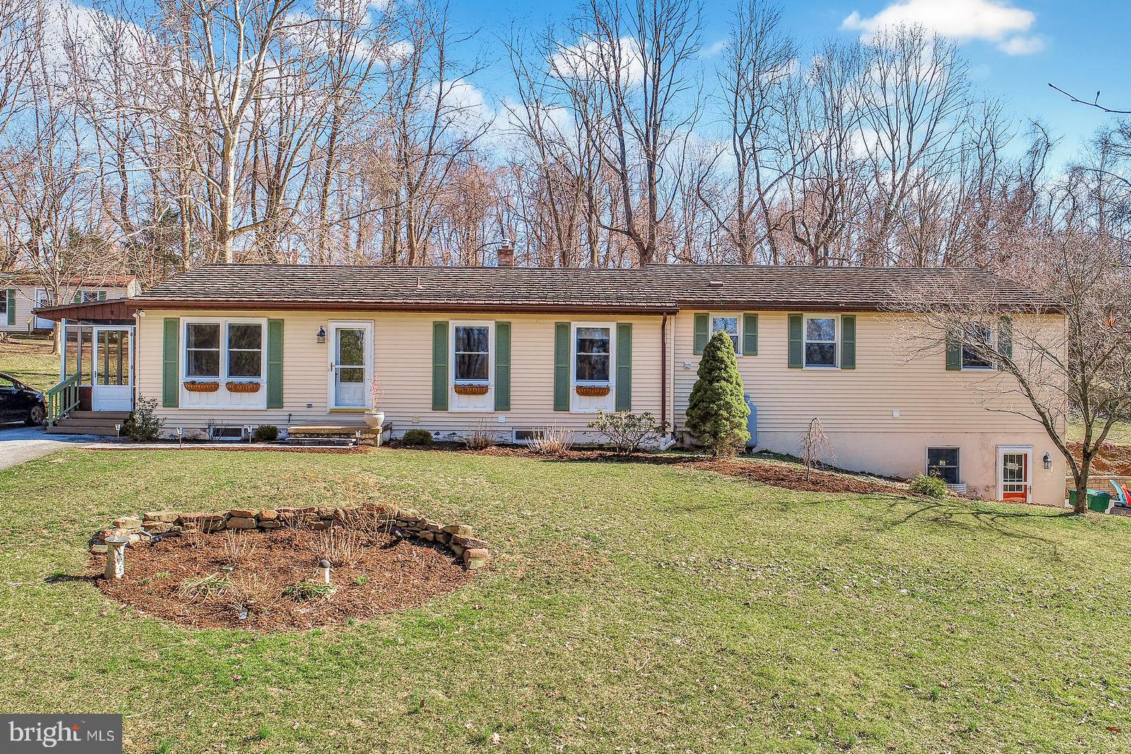 Come see this beautifully updated ranch situated on a 1.10 acre country lot, featuring a cook's kitchen with gas cooktop, granite counters, cork flooring, double ovens with convection, and updated appliances.  Brazilian chestnut floor in spacious living and dining rooms.  Wonderful master bedroom retreat with office and walk-in closet.  Office is plumbed for future master bath.  Convenient first floor laundry. The upgrades continue in the finished lower level, including a second kitchen, a remodeled bathroom with heated tile floor, 5th bedroom and a two sided gas fireplace in the family room and kitchen area. Enjoy this peaceful setting from the screened side porch and covered rear porch.  Ample parking with new stone retaining wall and oversized 2 car garage with storage closets. A detailed list of renovations is available. Possible in-law suite in lower level.