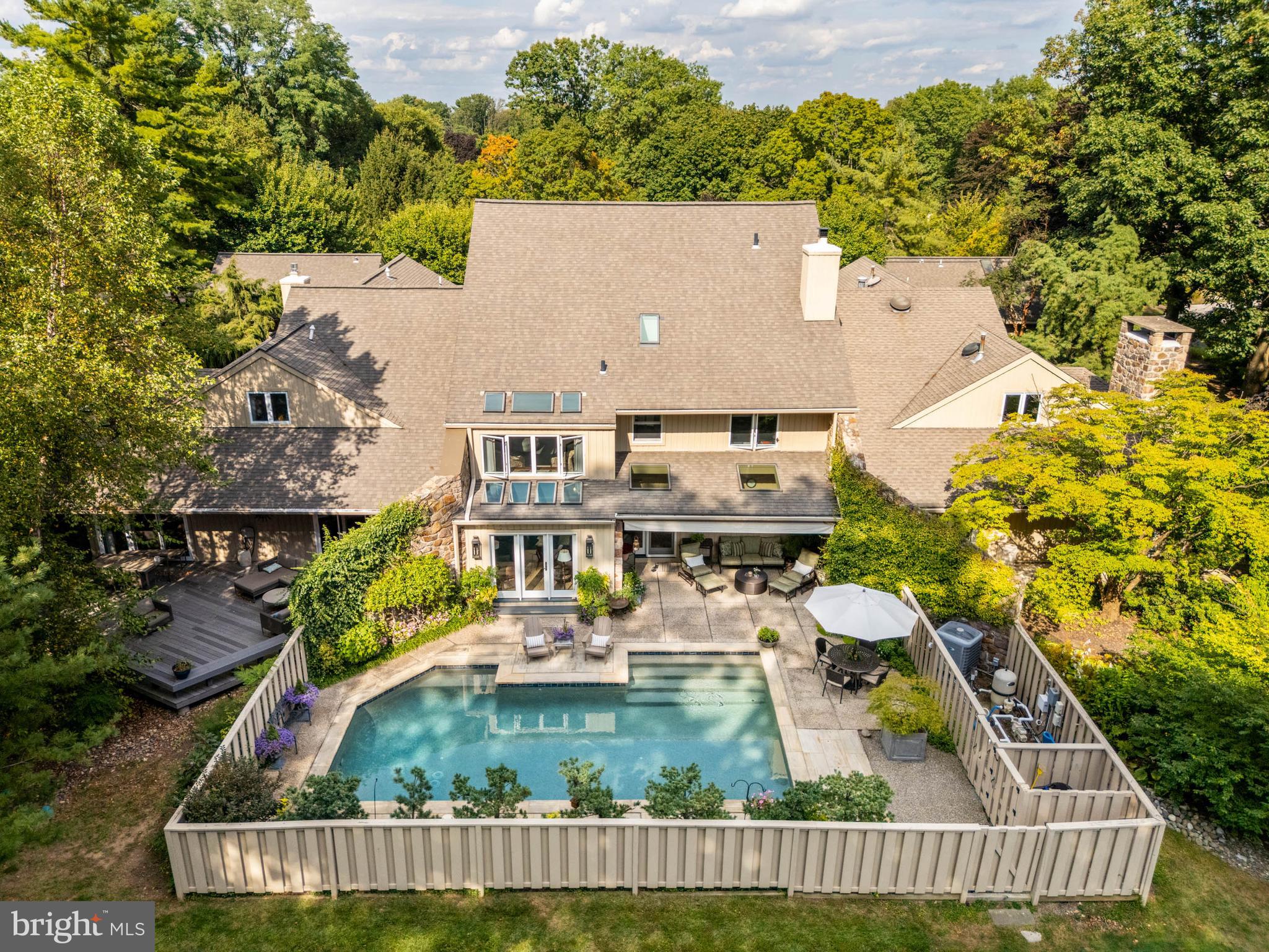 Welcome to 1034 Raffles Lane, an interior unit tucked within the desirable Hermitage neighborhood of Bryn Mawr. This 4-bedroom, 3.5-bath residence offers the perfect balance of privacy, style, and modern convenience in a serene setting.
The main level is thoughtfully designed for both everyday living and entertaining. A light-filled living room with soaring ceilings and a striking stone propane fireplace opens to an oversized dining room and a stylish den. Nearby, the contemporary two-tone kitchen and cozy breakfast room with a second fireplace create warm spaces for casual meals and gatherings. Designer-selected finishes throughout bring a fresh, timeless aesthetic.
Upstairs, you’ll find three spacious bedrooms, including the primary suite with a beautifully renovated ensuite bath and private sitting room. A separate guest suite above the garage offers comfort and privacy for visitors or extended stays.
Outdoors, the home truly shines with a private pool drenched in sunlight, a generous patio for lounging and grilling, and a retractable shade for summer comfort. At the front, a lush, plant-filled courtyard provides a peaceful retreat that feels like your own secret garden.
Tucked in a quiet corner of the Hermitage community, this home combines tranquil living with convenient access to everything Bryn Mawr and the Main Line have to offer.
1034 Raffles Lane isn’t just a home—it’s a lifestyle of comfort, beauty, and ease.