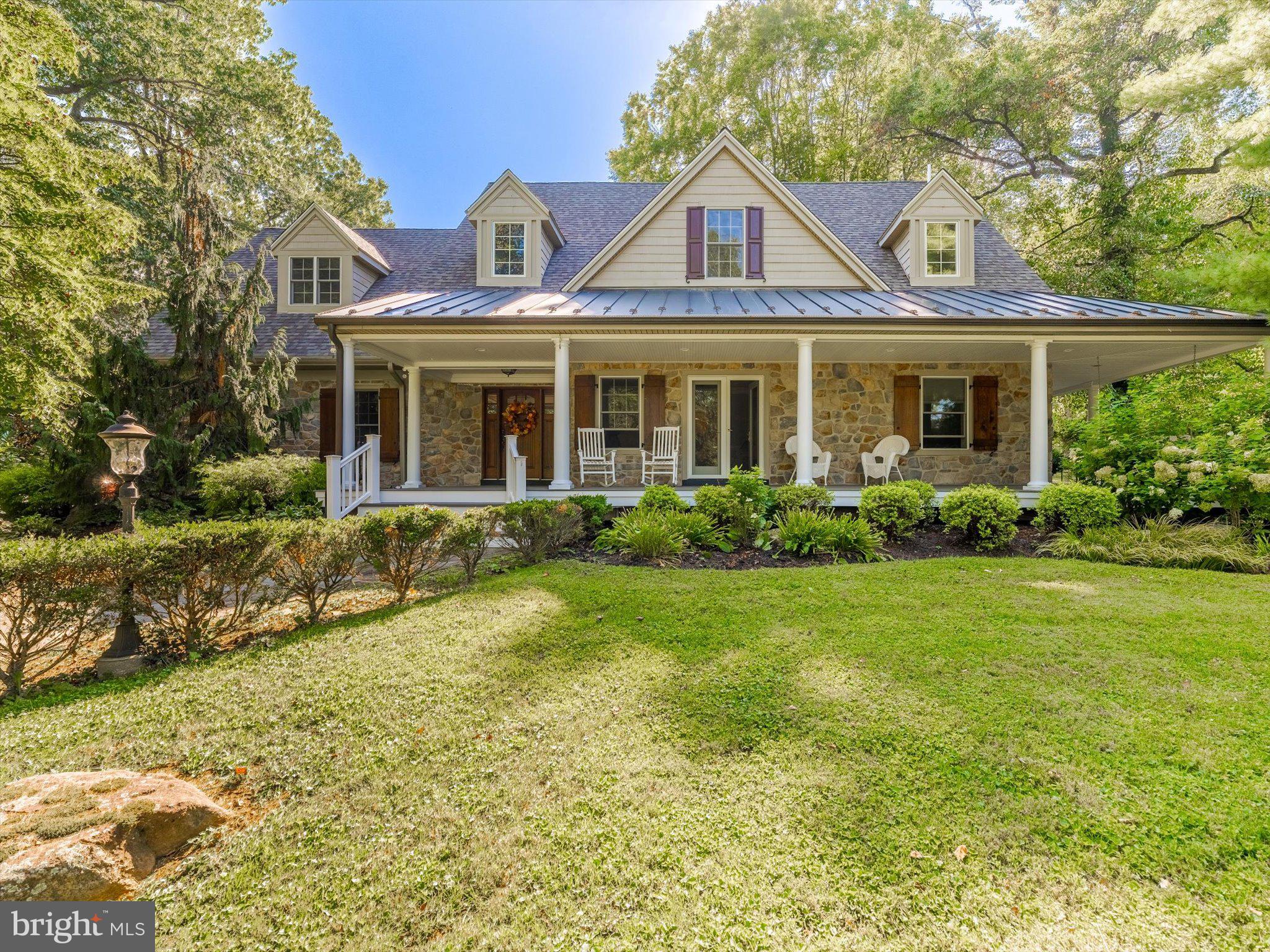 Discover your dream home where elegance meets comfort in this stunning one-of-a-kind custom residence featuring 4 bedrooms and 5.5 baths across 4,279 sq. ft. of thoughtfully designed living space. Set on 2+ acres, this home boasts a wrap-around porch, new roof, and new gutter guards.
Step inside to find sophisticated coffered ceilings and gleaming Antique Heart Pine hardwood floors that add timeless appeal. The formal dining room, anchored by a fireplace, sets the stage for memorable gatherings, while the family room’s own fireplace creates a warm, inviting atmosphere. At the heart of the home, the custom eat-in kitchen with oversized island flows seamlessly into daily life, complemented by cozy radiant flooring. A stylish wet bar elevates entertaining. The spa-like primary suite offers a tranquil retreat with radiant-heated floors and luxurious finishes that transform daily routines into indulgent experiences. Upstairs, fresh paint and new carpet highlight three generously sized bedrooms, each with its own ensuite bath.
The finished basement expands your living options with a home office, laundry room, and flexible recreation space. An oversized detached 4-car 2-story garage provides ample room and potential  (with Township approval) for multi-generational living. Outdoors, enjoy endless opportunities on a private, landscaped lot designed for entertaining or relaxation, as well as the ambiance of sitting on your front porch, enjoying the beauty of Tyler Arboretum with your favorite beverage. Nestled in a sought-after Media location, in Rose Tree Media School District, as well as a short walk to Ridley Creek State Park with walking trails, fishing & many more outdoor activities. The town of Media, the new WAWA Train Station & Shopping are only minutes away! This exceptional property blends custom craftsmanship, flexible living, and a prime setting—truly a rare find.