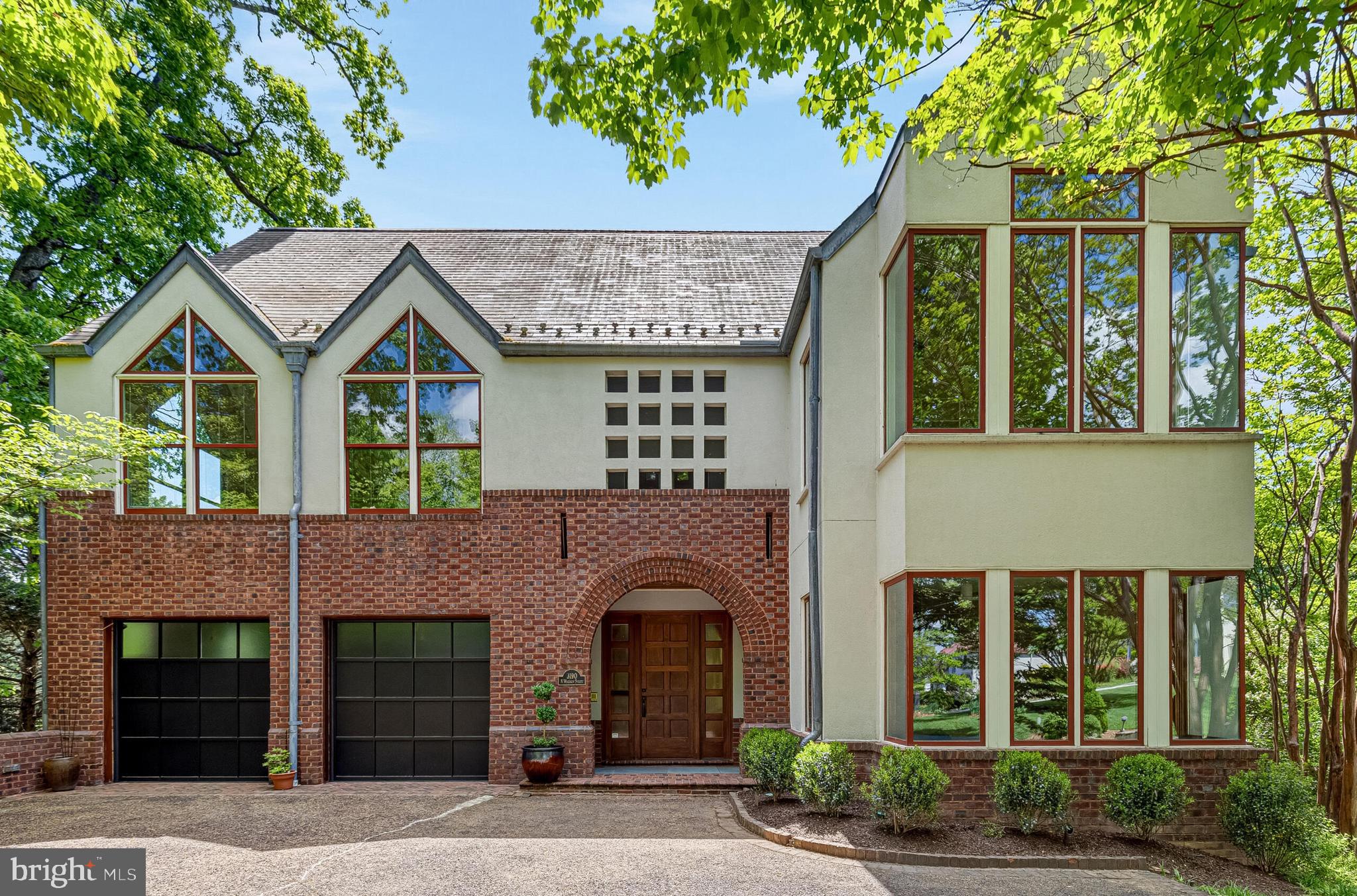 Set prominently atop a quiet crest overlooking the Washington Golf & Country Club, this architecturally significant custom residence is being offered publicly for the very first time since its completion in 1999.

Thoughtfully designed by a family architect for its original owners, the home was conceived as a sophisticated modern retreat—one that balances contemporary design with a timeless respect for its traditional surroundings. Privately sited on a narrow, sloping lot, the residence unfolds vertically across approximately 5,400 square feet, with interiors intentionally oriented to capture natural light, sweeping views, and a remarkable sense of openness throughout.

At the heart of the home, a dramatic central stair hall serves as both an architectural focal point and an organizing element, connecting expansive living spaces with striking visual continuity. Custom millwork, rich wood detailing, and carefully curated material selections create warmth and depth rarely found in contemporary homes of this scale.

The upper level was intentionally designed for everyday living, featuring the primary suite alongside the main entertaining spaces—allowing for effortless flow between the kitchen, dining, and living areas. Guest bedrooms are thoughtfully positioned on the entry level, while the lower level offers exceptional additional living space, highlighted by a remarkably large above-grade family room lined with expansive windows that fill the space with natural light. Bright, open, and connected to the surrounding landscape, it serves as an inviting setting for recreation, entertaining, hobbies, or everyday relaxation.

Designed well ahead of its time, the residence also incorporates extensive “aging-in-place” features, including minimal-step access from both the main entry and garage, wide hallways and doorways, spacious baths, and elevator access to every level discreetly integrated into the home’s design.

The rear elevation opens dramatically toward the surrounding landscape and golf course vistas, contrasting beautifully with the home’s more understated street presence. The result is a residence that feels both private and architecturally expressive—equally suited for elegant entertaining and comfortable daily living.

Rarely does a home of this architectural pedigree, scale, and provenance become available in such a coveted setting.
