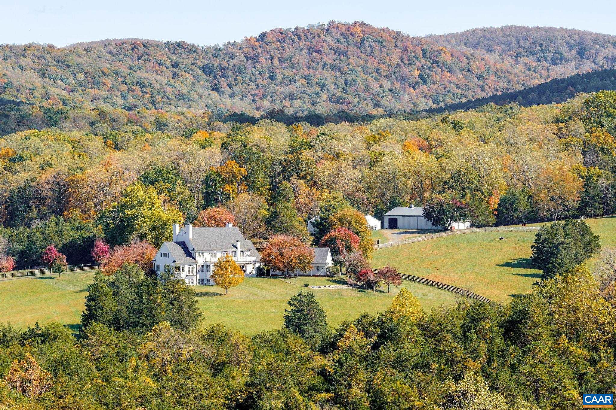 This extraordinary Georgian estate is set on 179 acres with two ponds, seven natural springs, and two barns, offering timeless elegance in a truly remarkable setting with additional subdivision and vineyard potential. Designed for both entertaining and everyday living, the home blends historic charm with modern comfort, all while capturing breathtaking mountain views from nearly every room. The main level offers a graceful mix of formal and casual spaces, including a first-floor primary suite, antique heart pine floors, and a handsome study. Upstairs, a second primary suite with a renovated bath enjoys panoramic vistas, complemented by three additional bedrooms with en-suite baths. The lower level is designed for recreation with a large screen viewing area, wet bar, billiards room and provides a welcoming guest bedroom, full bath and office. Seven fireplaces add warmth and character. Outdoor living boasts a free-form pool, wide porches, and sweeping vistas. A four-car garage with portico has a second floor roughed-in. Every detail reflects quality and sophistication, making this estate a rare opportunity where land, luxury, and lifestyle come together, and every feature is designed to elevate gracious country living.,Granite Counter,Wood Cabinets,Fireplace in Basement,Fireplace in Dining Room,Fireplace in Family Room,Fireplace in Kitchen,Fireplace in Living Room,Fireplace in Master Bedroom,Fireplace in Study/Library
