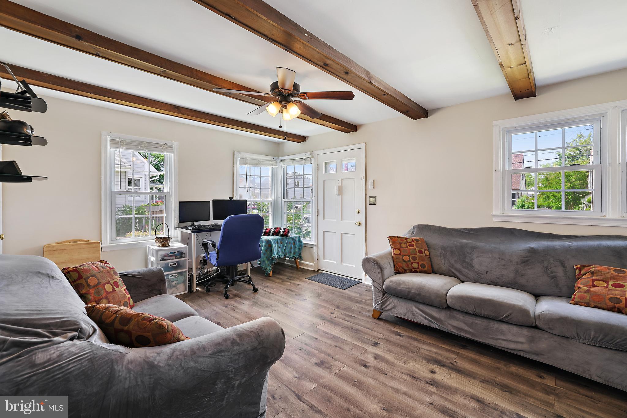 Adorable and Affordable  Cape Cod Now Available in Marlyn Manor!  Attractively priced!  This lovely home features newer vinyl flooring on main level and newer carpet in the bedrooms.  You'll love the natural daylight and open concept floorplan. Decorative beams and ceiling fans create a warm, welcoming feel.  Two spacious bedrooms on main level with full bath. Upper level primary bedroom or bonus living space.  The large fenced yard is perfect for entertaining or for peaceful relaxation.  Ample closet space and built-ins, plus two sheds for additional storage.  Plus the newly installed 2 car driveway provides plenty of off-street parking.  All appliances convey including the new washer and dryer.  This home is move in ready with neutral paint colors.  Sellers are contingent on finding home of choice and may need short rent back.   Located close to commuter routes, shopping and dining. Come and take a look...Don't miss out!