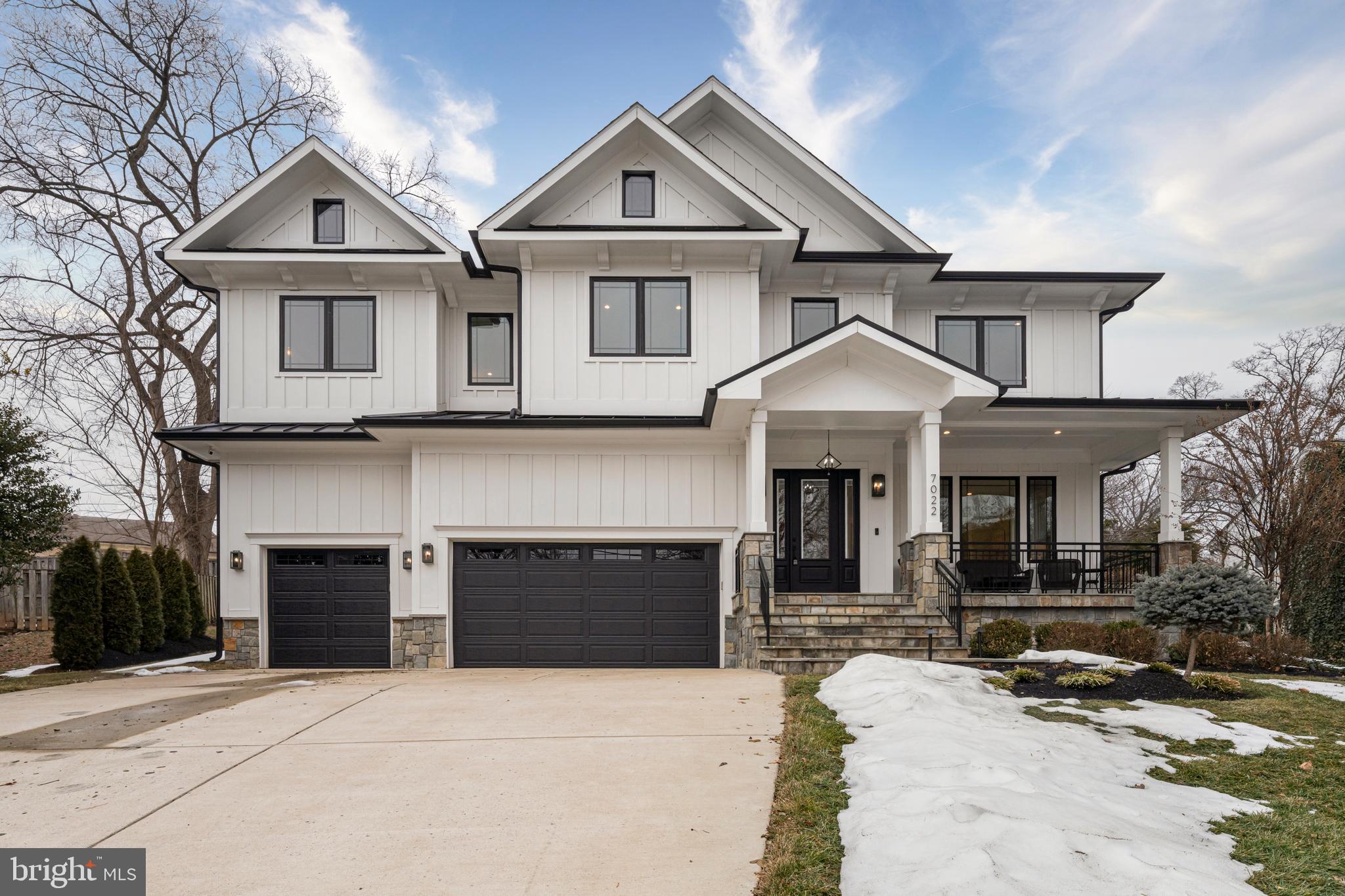 Impeccably crafted in 2019, 7022 Hector Road is an exceptional residence offering more than 7,000 finished square feet of refined living across three gracious levels in one of McLean’s most desirable neighborhoods. This seven-bedroom, seven-and-a-half-bath home presents a seamless fusion of contemporary elegance and timeless detail — from the three-car garage with bespoke organization to the fully fenced grounds and flagstone terraces that create a private, resort-like setting.
Enter into an open, light-filled main level defined by hardwood floors, expansive proportions and an effortless flow designed for both grand entertaining and everyday living. The family room, anchored by a floor-to-ceiling marble surround and a gas fireplace, opens thoughtfully to the chef’s kitchen and morning room. The kitchen is a study in luxury: a dramatic waterfall quartz island, soft-close cabinetry with under-cabinet lighting and a comprehensive suite of premium Thermador appliances — 48" refrigerator, 48" luxury gas cooktop with hood, double wall ovens — complemented by plentiful prep space and dual sinks. Practical elegance continues with a dedicated office with built-ins, a well-appointed mudroom with cubbies and pantry storage, and a main-level bedroom with private bath.
Ascend to a sumptuous upper level where the primary suite is a serene retreat, featuring two walk-in closets and a spa-inspired bath with heated marble floors, a deep soaking tub and a large frameless glass shower. Each additional bedroom on this floor boasts walk-in closets with custom organizers and private en-suite baths. A broad hallway with a loft-style sitting area and a full laundry room with cabinetry and granite counters complete this thoughtful floor plan.
The lower level expands the home’s entertainment repertoire with a generous recreation room, a media room warmed by a gas fireplace, and a convenient kitchenette with granite counters and beverage refrigeration — ideal for movie nights or casual gatherings. Two additional en-suite bedrooms provide flexible accommodations for guests, extended family or fitness and hobby spaces. Utility and storage needs are well met with abundant storage, mechanical systems and service provisions throughout.
Outdoors, meticulously executed hardscaping — including flagstone front stoop and covered rear patio, retaining walls and architectural exterior lighting — frames a fully fenced backyard refined with a relaxing hot tub. Positioned within the Churchill Road Elementary, Cooper Middle and Langley High school pyramid and moments from downtown McLean, parks, community amenities and major commuter routes, this home delivers elevated living, privacy and unparalleled convenience in an established enclave.